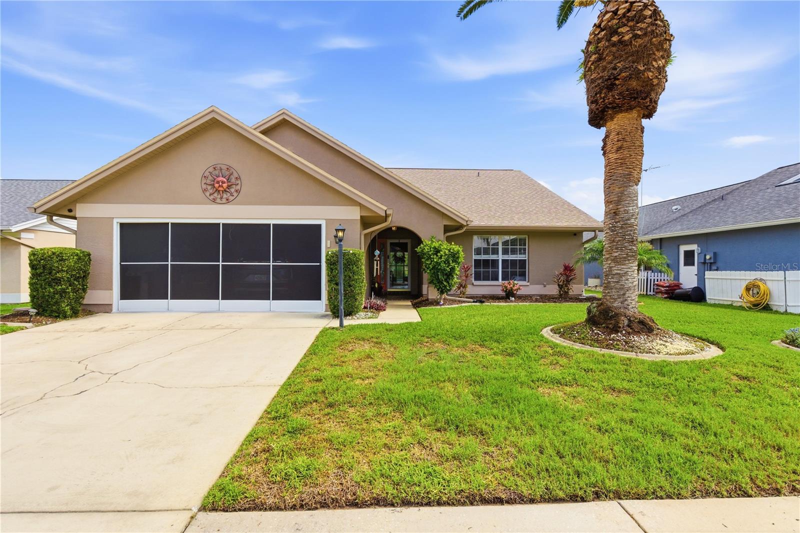 Welcome to this stunning and meticulously maintained 2-bedroom, 2-bath pool home located in the highly sought-after golf course community of Meadow Oaks! Perfectly situated with no rear neighbors, this beautiful home offers privacy, peaceful views, and exceptional outdoor living. The lush, well-maintained landscaping features a banana tree, fresh herbs, colorful shrubs, and palm trees creating your own private tropical retreat. Inside, you’ll find an open and inviting floorplan with soaring vaulted ceilings, luxury vinyl plank flooring throughout the main living areas, and ceramic tile in the kitchen and baths — absolutely no carpet. A beautiful wood feature wall adds warmth and character to the spacious living area, while the kitchen is equipped with newer stainless steel appliances and overlooks the heart of the home. Step outside to enjoy your sparkling screened-in pool, perfect for relaxing or entertaining year-round. Major updates provide peace of mind, including a new roof (2023), AC (2020), pool pump and filter (2022), exterior paint (2022), pool screen enclosure (2021), garage screen (2022), and water softener (2024). This move-in ready home combines comfort, style, and Florida living at its finest in one of the area’s most desirable golf course communities and on a cul-de-sac street with the type of neighbors that set up outdoor tables and hold pot lucks for holiday fun year round.