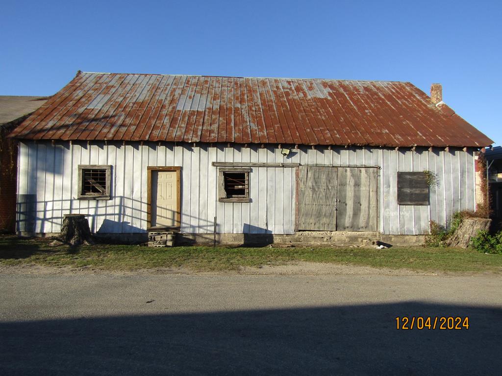 Great opportunity to own a massive industrial shell in Pelham, GA. This expansive warehouse features industrial-grade concrete flooring and has a double entry door, making it ideal for heavy storage, or custom manufacturing. This property is currently offered without utilities, providing an advantage for investors, or owners who want a fully customized building! By starting with a clean slate, you can install the specifics! Call today for a showing!