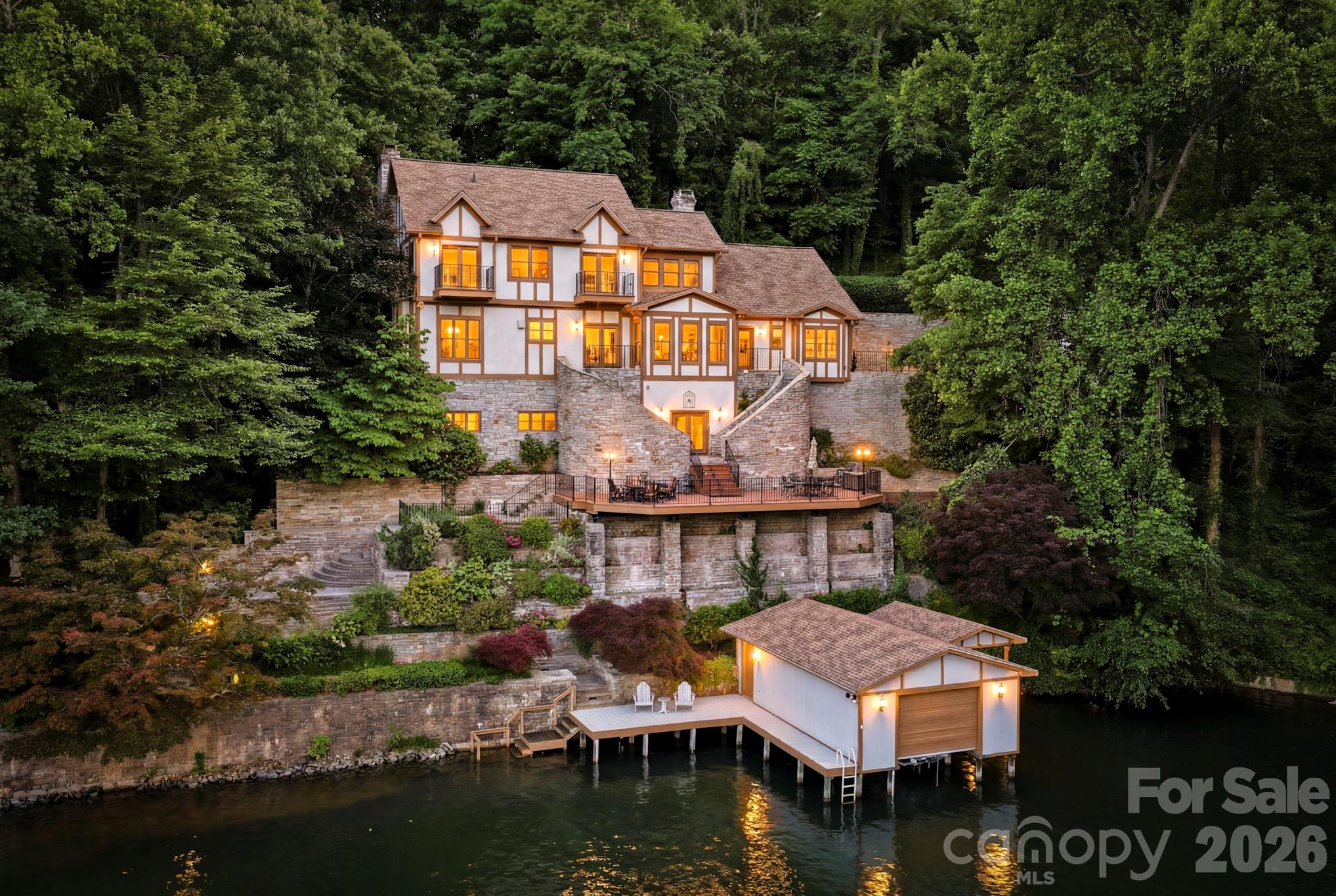 LAKE LURE LAKEFRONT.....Discover 4,400 sq ft of refined lakefront living in this 4 bedroom, 3 1/2 bath, custom home perfectly sited on beautiful Lake Lure, offering wide open water views from the privacy of serene Garner Cove. Built like a fortress with meticulous attention to detail, this spectacular residence is graced with hand-painted faux walls, rich custom cabinetry, multiple fireplaces and a luxurious blend of Italian travertine and hardwood flooring throughout. Step outside to impeccable landscaping and a new concrete driveway, while recent upgrades including new windows and a new roof provide peace of mind and long-term value. Inside, you'll appreciate thoughtful comforts such as heated bathroom floors, integrated smart switches and the fastest fiber-optic internet available in the region through Pangaea, ideal for remote work, streaming and smart-home living. A finished 2-car garage with epoxy floor along with a custom boathouse right on the water, completes this exceptional lakefront package. Offered at $2,400,000, this remarkable home blends luxury, durability and modern convenience in one of Lake Lure's most sought after settings.