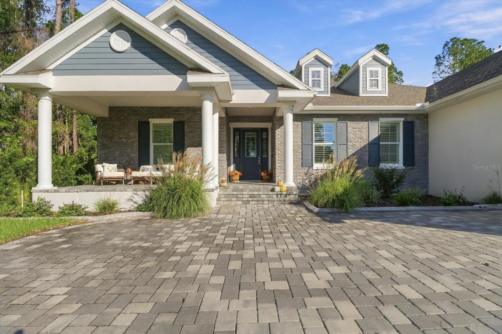 Built in 2024, this 3-bedroom, 3-bathroom, 2,605 sq ft single-family home in Southern Hills sits on a nearly half-acre lot backing to a greenbelt for ultimate privacy in Brooksville, Florida. It comes loaded with custom builder upgrades, an outdoor kitchen plumbed for water and gas, and an oversized two-car garage with room for a golf cart, motorcycle, or recreational vehicle. The chef’s kitchen features an induction cooktop, Frigidaire Gallery appliances, a Samsung Bespoke refrigerator/freezer, and 42-inch wood cabinets with under-cabinet lighting. Recessed lighting and upgraded ceiling fans run throughout the living spaces, and an upgraded Trane Hyperion Series air handler with humidity control keeps the home comfortable all year. Step outside to a lanai with electric drop-down screens and an outdoor kitchen ready for entertaining, all overlooking the greenbelt with no rear neighbors. The garage offers overhead storage with a lift that makes moving seasonal items up and down effortless. Southern Hills is home to a renowned Pete Dye-designed golf course, and the community sits minutes from downtown Brooksville and the Suncoast Parkway. Thoughtfully built, move-in ready, and set on almost half an acre, this home in premier Southern Hills is waiting for you to see it in person.
