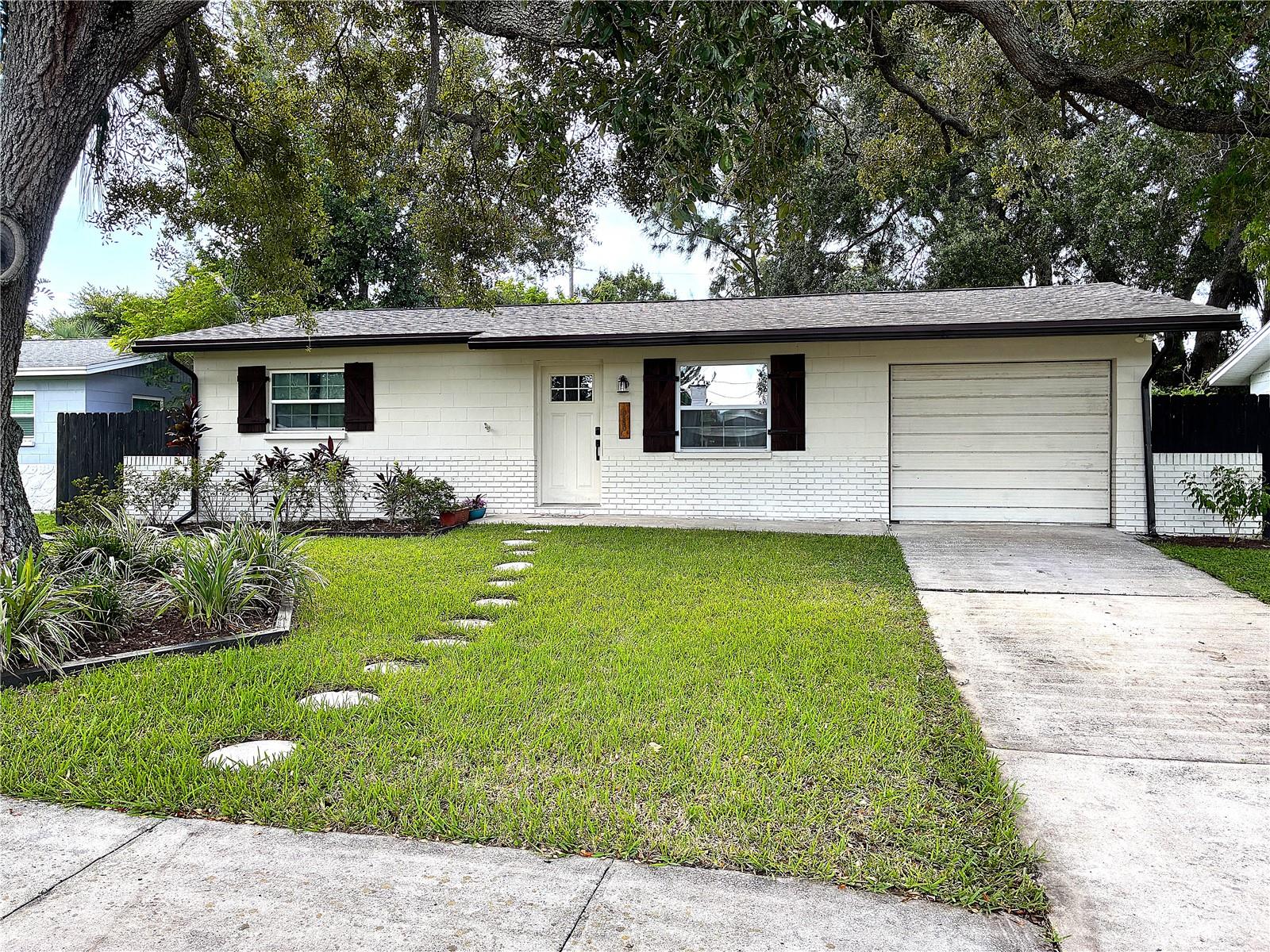 A grand Live Oak tree stands guard over the front facade of this cozy ranch home.  Its lush greenery provides the Brand New Roof with shade keeping your energy bills low and the curb appeal high.  The home was garnished with a nearly complete set of upgrades in 2019.  Including new paint, Kitchen cabinets, Kitchen Appliances, counter tops, tub, shower, vanity, toilet, and the list goes on.  Luxury vinyl plank comforts your feet while the recessed lighting highlights the butcher block island countertop.  In 2019 a new electrical panel was installed to go along with the hot water heater.  The central Air Conditioning and all ductwork was also installed in 2019.  A drinking water reverse osmosis purifying system is undersink and provides up to 100 gallons a day of purified drinking water.  The new roof boasts shingles with a wind rating of over 150 mph!  A fenced in extra large back yard has plenty of space for growth and pets.  This home is updated and well maintained, all it is waiting for is you!  Welcome Home.