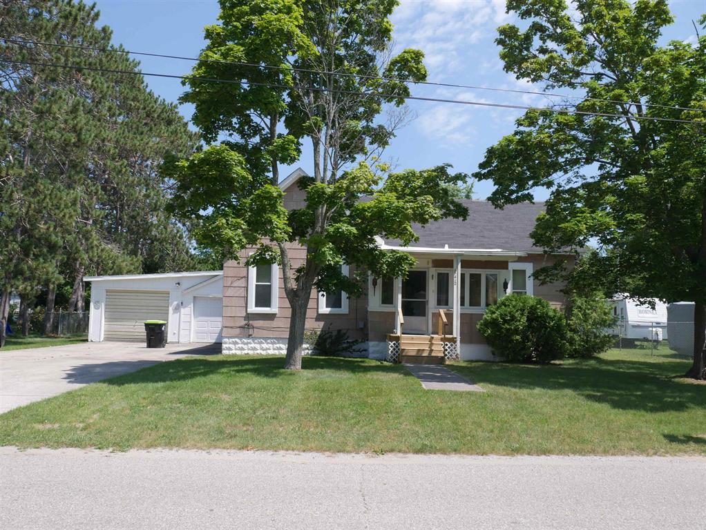 Lots of potential for this home with natural gas, city sewer and city water, fenced in back yard, close to Tawas Bay and down town shopping and restaurants. Custom made cabinets and trim, original wood flooring under carpet in living room and dining room, central air, would make a great family home with some TLC!