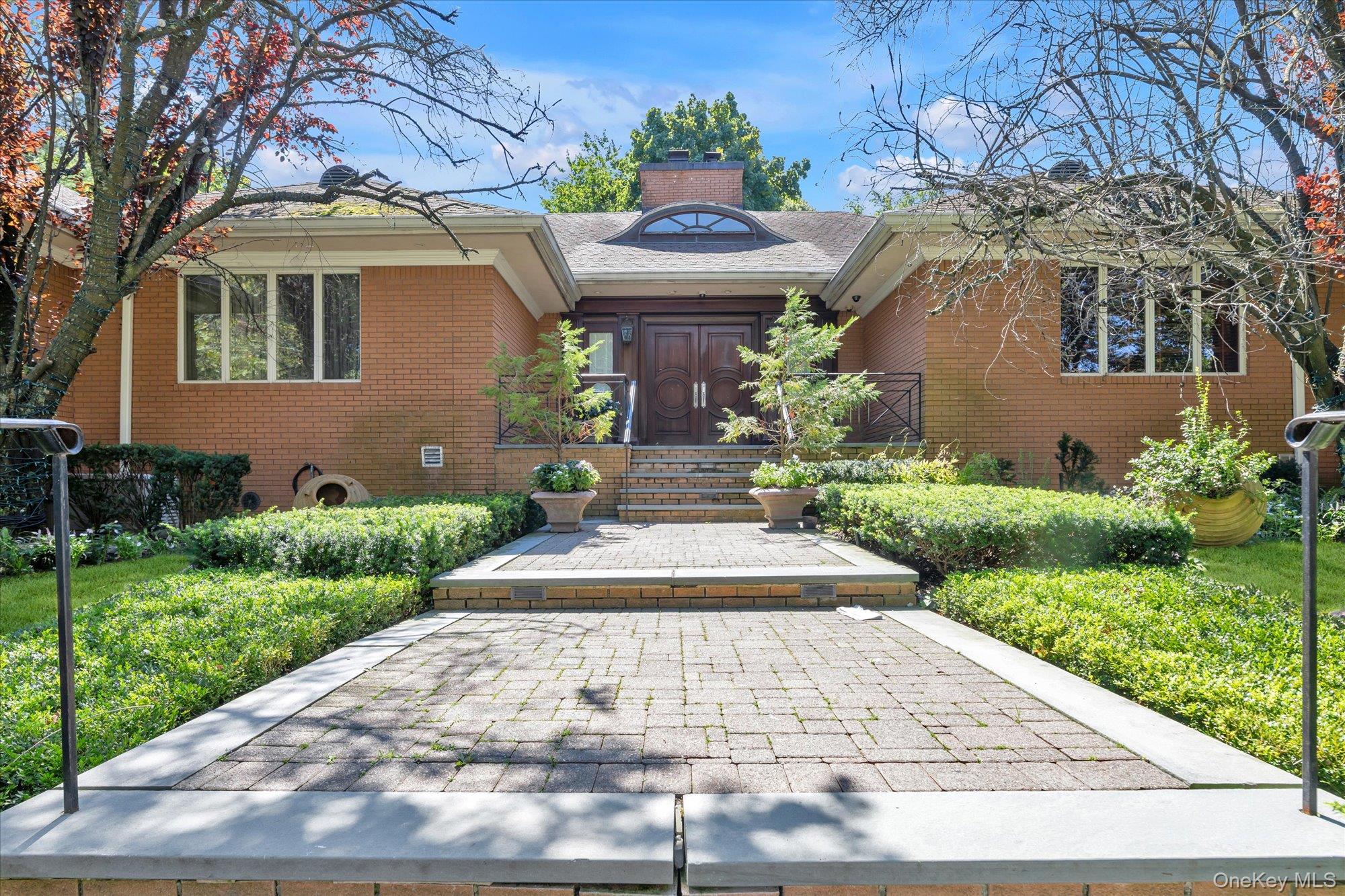 This SPRAWLING Ranch in the heart of the waterfront community of Douglas Manor sits on an impressive 16,000 sq. ft. lot. With over 9,800 sq. ft. of living space, this home is elegant yet inviting and thoughtfully designed with generously sized rooms and exceptional amenities. From the moment you enter the grand foyer with its dramatic 20-foot domed ceiling, you’ll notice the beautiful custom millwork, elegant archways, architectural ceilings, and carefully placed skylights that bring an abundance of natural light into the home. An impressive gallery-style corridor, framed by graceful archways, runs through the heart of the home, creating a seamless flow from room to room. Radiant heat beneath all tile and stone floors, along with multiple heating and cooling zones throughout the home, provide exceptional year-round comfort.Over 4,800 sq. ft. of living space on the main floor features four spacious bedrooms, including an impressive primary suite with a spectacular two-level custom walk-in closet. A large home office offers the flexibility to serve as an additional bedroom. The sunken formal LR, formal DR, and den provide large spaces for both everyday living and entertaining. The gourmet kitchen and breakfast area feature a large center island with an additional sink and top-of-the-line appliances, including a Sub-Zero refrigerator, Viking stove and warming drawer, wine refrigerator, dishwasher, and microwave. Gas fireplaces add warmth and ambiance throughout the home, while radiant heating, central vacuum, and a whole-house generator capable of powering the entire home add another level of comfort, convenience, and peace of mind. French doors from the kitchen open to the patio and backyard. Enjoy the in-ground pool, outdoor kitchen, and generous space for dining, lounging, and gathering with family and friends.And then there’s the lower level - another 4,800 sq. ft. and an entertainer’s dream! This expansive space features an in-law suite, large entertainment room, wine room, wet bar, gym, and your own private spa retreat complete with a steam room and sauna.An attached two-car garage and wide driveway with parking for four additional cars provide plenty of off-street parking.The Douglas Manor Association maintains the shared waterfront and provides private security. Residents also have the opportunity to join the Douglaston Club, which offers a pool, tennis courts, dining, and year-round social events.