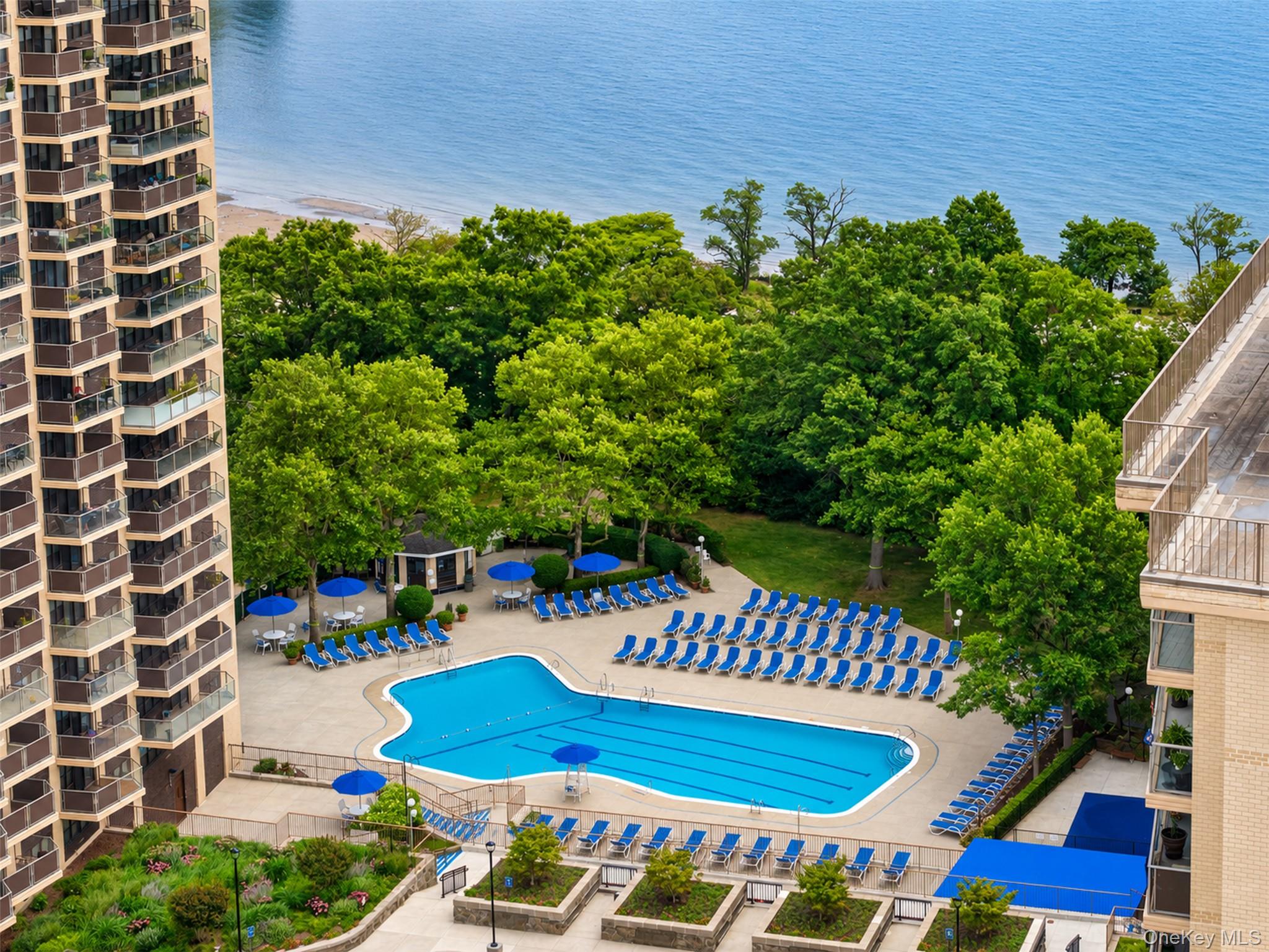 Welcome to the 16th floor of The Versailles, set within the luxury, resort-style waterfront community of Towers at Water’s Edge. This high-floor H-model 2-bedroom, 2-bathroom unit offers over 1,000 square feet of living space, with oversized windows and 24-foot balcony framing expansive, unobstructed bridge and open-water views overlooking Little Neck Bay. Renovated in 2018, this turnkey home pairs wood-look tile flooring, crown molding, stone counters, and stainless steel appliances, including gas range with exterior-vented exhaust and dishwasher, with an open living/dining area designed for both everyday comfort and entertaining. The flexible second bedroom with French doors opens to the living room and can function as a formal dining room, home office, or traditional 2nd bedroom, giving you options as your lifestyle evolves. The spacious primary suite features dual closets and a private en-suite bathroom, while the additional full bathroom with serves guests and day-to-day living. Thoughtful modern updates throughout and a neutral palette make this a true move-in ready home. The community offers a heated outdoor pool with sun deck, fitness center with Peloton equipment and group classes, four tennis courts including pickleball, basketball court, playground, landscaped common areas, an on-site cafe/deli, spa, dry cleaning, and a full calendar of seasonal events, turning everyday living into a curated five-star experience. Residents also have peace of mind with a 24-hour doorman and attended garage parking. Commuters have easy access to nearby Q12/Q13/Q31 buses, express buses to Manhattan, and Port Washington LIRR, while nature lovers have Fort Totten waterfront and Little Neck Bay moments away, and foodies or night-owls can head to Bay Terrace and Bell Boulevard for upscale dining and a night on the town.