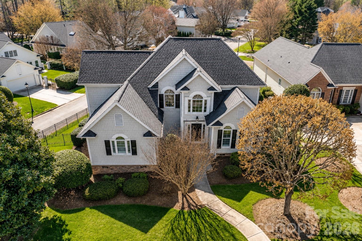 Updated from top to bottom and beautifully situated in The Peninsula, this move-in-ready home combines timeless curb appeal with thoughtful modern improvements throughout.  Beautifully updated and exceptionally well maintained, this inviting home in The Peninsula offers the perfect blend of timeless style, modern updates and an enviable Lake Norman lifestyle. Set on a beautifully landscaped lot with mature trees and established landscaping, the home makes an impressive first impression with its charming shingle exterior, stone accents and welcoming front entry.Inside, refinished hardwood floors, fresh carpet and abundant natural light create a warm and polished atmosphere. The updated kitchen opens to the spacious great room, creating an ideal setting for both everyday living and entertaining. The great room features a fireplace and easy access to the outdoor living space.The main-level primary suite provides a private retreat with an updated bath and newly added hardwood flooring. Upstairs, additional bedrooms and flexible living space offer plenty of room for family, guests or a home office.Thoughtful improvements throughout include updated bathrooms, an updated kitchen, refinished hardwood floors, new carpet, updated HVAC, a new roof, new driveway and fencing, whole-home air filtration, reverse-osmosis water filtration and an alarm system—offering the comfort of a home that has been thoughtfully cared for and improved.Outside, mature landscaping and established trees create a beautiful setting, while the home's location within The Peninsula puts you close to the community's exceptional amenities and all that Lake Norman has to offer.