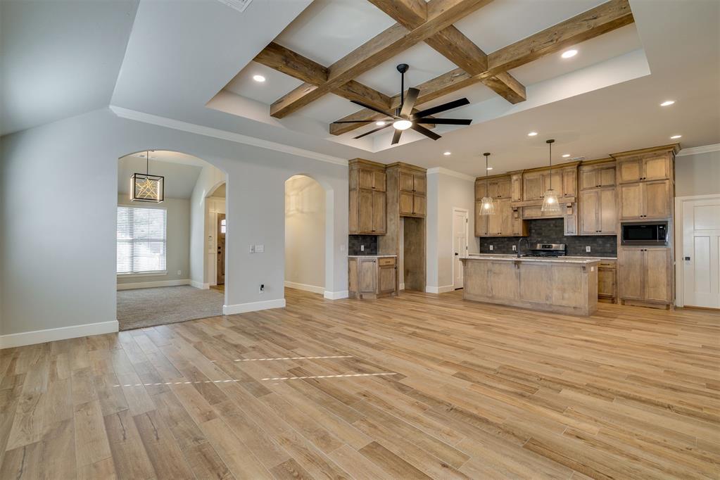 You will love the cozy community feel of The Springs with amenities perfect for any age in this better than new, very well taken care of one owner custom home and an HOA that does the work for you! This well appointed home is on a desirable corner lot. A lot of thought was dedicated to this build including the over sized garage, and additional concrete added on the side of house! The floor plan is open and offers a flex room area that can be used for anything you need. From the moment you walk into the grand entry you will feel at home and notice all of the unique and high end light fixtures and wood beams on the ceiling! The wood like tile is gorgeous with the granite and designer colors. You will love the hidden pull out spice racks in the kitchen, the walk in pantry and huge island. Large sliding glass door that leads to the covered back patio is breathtaking. This home has a very large laundry room with its own sink, additional deep utility closet and mud bench! The primary bedroom has a sliding barn door that leads into the large primary bathroom with a huge walk in shower additional linen closet and massive walk in closet. This is an energy star rated home and comes with a transferable builder warranty! You will enjoy the conveniences of this home including a full sprinkler system, and the HOA that does your fertilizing and lawn mowing for you! The community is loaded with a gated entrance, a rec facility, in ground swimming pool and indoor gym! The average cost in Edmond/NW OKC for the amenities that the HOA covers is $2,250 a year that includes lawn mowing, fertilization, flowerbed/tree maintenance, gym membership and pool access. For an additional $630 a year to total the $2,880 annual HOA costs, you get the gate, private streets, common area maintenance and landscaping, access to parks, splash pads, and walking trails in Valencia. With all of these desirable features and Deer Creek schools, this just went to the top of your list! Buyers to verify schools.