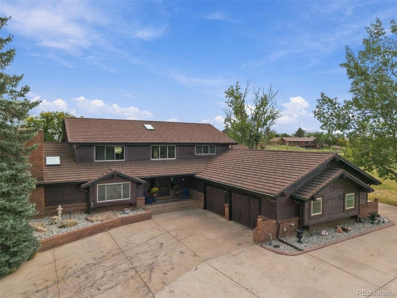 Welcome to an extraordinary Commerce City estate delivering an incredible 5,000+ square feet of living space on over 2 pristine acres of freedom. This rare property seamlessly pairs a massive, luxurious residential footprint with unmatched outdoor utility and equestrian readiness, making it the ultimate dream for hobbyists, car enthusiasts, and horse lovers alike. Step inside the main residence to discover a bright and expansive 4-bedroom layout. The main level is highlighted by a luxurious, expansive primary suite, offering a peaceful retreat with plenty of breathing room. The main floor also features a stunning, sun-drenched sunroom perfect for your morning coffee. Entertainment options abound in the massive finished basement, which boasts a large game room ideal for movie nights, billiards, or a home gym. The exterior amenities are unmatched, boasting two massive outbuildings and equestrian setups: The New Shop: A brand-new, detached 1,200-square-foot garage professionally engineered with soaring ceiling clearance built specifically to accommodate a full-sized vehicle lift. The Second Garage: An additional detached 1,000+ square foot garage featuring a highly functional loft space, perfect for extra storage, a home office, or a studio. Horse Amenities: Multiple horse loafing sheds ready to welcome your animals on over 2 flat, usable acres. Properties of this scale, featuring premium multi-garage workshops and horse setups so close to the city, are exceptionally hard to find!