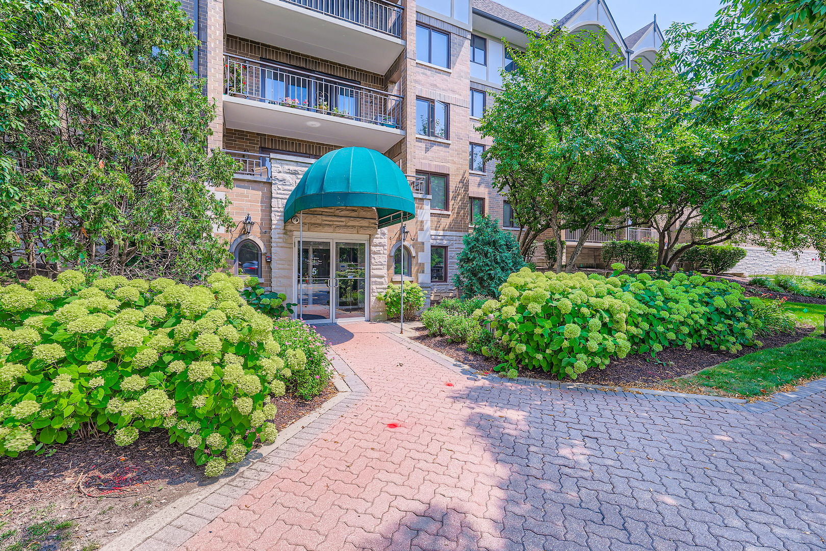 Fabulous Updated Mount Prospect Downtown Condo w/ Heated Indoor Garage Parking! Shows like a Dream!  Private Covered Balcony W/ Picturesque Views Overlooking Trees! Gorgeous  & Popular Shires At Clock Tower Elevator Building is minutes to Metra Train Station! Dramatic Open Floor Plan w/ Foyer Entry, White Trim & 6-Panel Doors t/o! Spacious & Open Eat-In Kitchen w/ Quartz Countertops, Stainless Steel Appliances, Porcelain Floor, White Cabinets, Ceramic Backsplash, Pantry Cabinet & Pillars open to Dining Room! Huge Living Room w/ Wood Laminate Floors & Sliding Glass Door to Large Private Covered Balcony! Primary Bedroom w/ Walk-In-Closet & Wood Laminate Floors! Full Bath w/ Quartz Counters & Ceramic Floors! In-Unit Laundry includes Washer & Dryer!v New Central Air August 2025! Extra Large Private Storage Room next to Heated Parking Space! A Commuters Dream close to Shopping, Train, Restaurants, Parks & Library! An Absolute Must See!