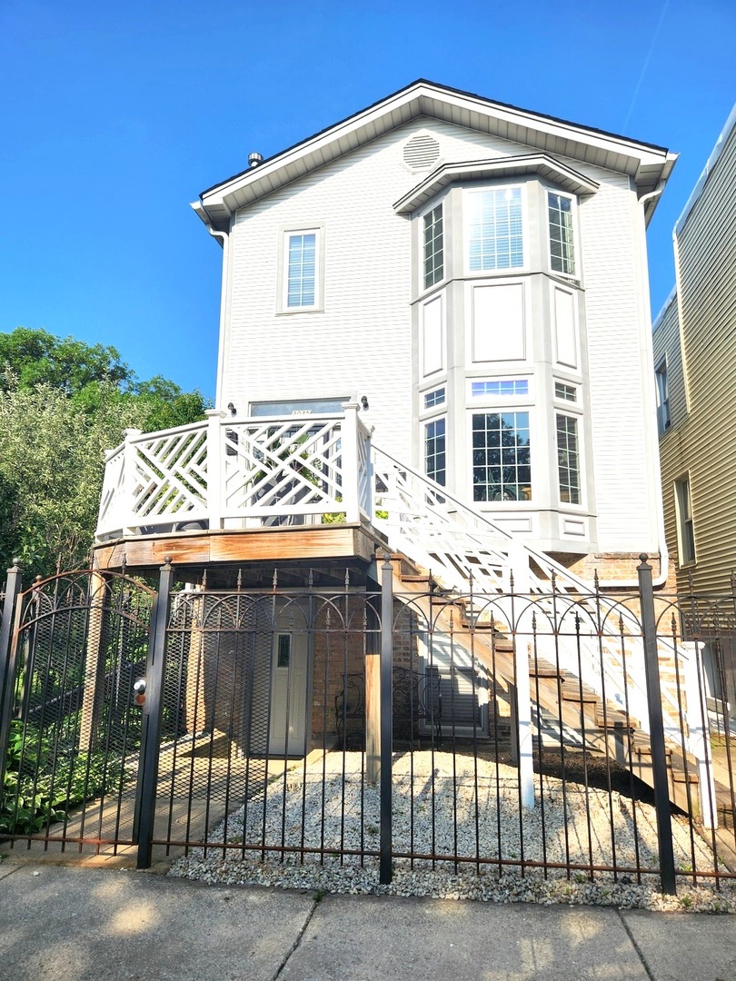 Modern Victorian Beauty in the Heart of Logan Square - Wide Lot, Endless Possibilities! This rare 50 x 125 double lot property blends timeless Victorian charm with modern updates, offering a lifestyle that's as practical as it is stunning. Bathed in natural light from multiple skylights and enhanced by the openness of an extra side lot, this home feels bright, airy, and welcoming from the moment you step inside.  An entertainer's dream -featuring a chef's kitchen, a great room, a separate dining area, and multiple private decks (one off the dining room, one off the great room, and another off the primary suite upstairs), perfect for hosting or unwinding. Thoughtful, custom-built-in features, abundant storage, and unique design details make this home stand out. The primary suite is a retreat in itself, with a spacious walk-in closet with skylight (plumbed for a future spa bath), two additional closets, a private deck, and sunlit bay windows in both the front bedroom and living room. Downstairs, a beautifully updated 1-bedroom in-law suite (or rental) offers its private entrance, in-unit washer/dryer, and well-maintained finishes -ideal for extended family, guests, or extra income. Outdoors, the property offers incredible flexibility - create an oversized yard, lush garden, or expansion space alongside the existing cherry tree. A two-car garage, parking pad, and additional storage for seasonal items complete the package. Located in one of Chicago's most vibrant neighborhoods, this home delivers on every front -investment potential, modern comfort, and a prime location. Opportunities like this don't come often!