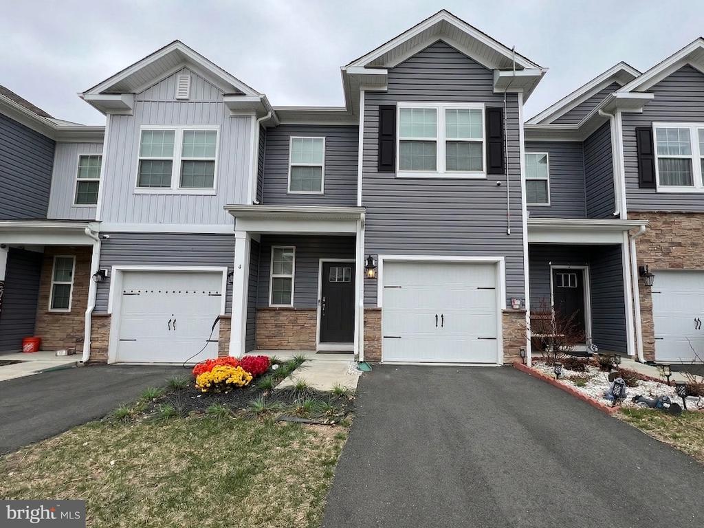 Welcome to your exceptionally well maintained luxurious townhome! 4 Peregrine Way is located within the Capital Crossing community and offers 3 bedrooms, 2.5 bathrooms, attached garage, curb appeal surrounding the 2-car driveway, and a fenced backyard! Upon entry you are greeted by an open concept and modern floor plan which greets you into a cozy living space with ample natural sunlight, high 9 foot ceilings with recessed lighting. The dining room is adjacent to the kitchen equipped with stainless steel appliances, quartz countertops, shaker style cabinets, and a pantry with shelving for additional storage. The living room is suited for relaxation, entertainment, suitable space for gatherings and provides access to the patio and fully fenced backyard for added privacy and recreation in your outdoor space. The main level also includes a powder room and interior access to the garage.The second floor includes the primary suite with en-suite bathroom with a dual sink vanity, and walk-in closet space. The additional bedrooms include closets for guests accommodation, family, or home office, and laundry room along with full bathroom conveniently located within the hallway.Additional features include a solar panel and a Tesla charging station in the garage for added energy efficiency and substantial energy savings. Lastly, there is still 7 years remaining on the builder warranty!!Commuter friendly with easy access to I-295, NJ and PA turnpike, less than 10 minutes from Downtown Burlington, and many nearby local amenities including dining, shopping and parks.This property is move-in ready and available for you to tour, schedule your showing today!