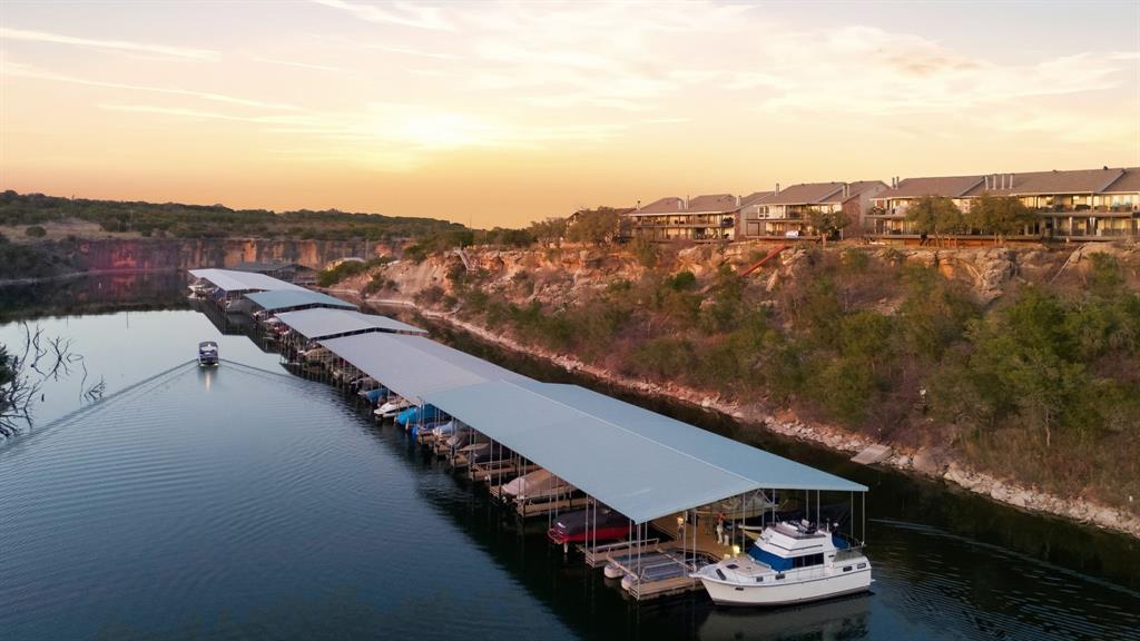 Beautifully REMODELED lakefront retreat offering the perfect blend of luxury,convenience, and breathtaking cliff line views! This home features open-conceptliving designed to maximize natural light and features high-end finishes throughoutcreating a refined yet comfortable atmosphere ideal for relaxing and entertaining.Step outside to the expansive PRIVATE patio and enjoy serene scenic lake views andbreathtaking sunsets over picturesque Set Ranch. Designed for effortlessownership, this property offers easy lock-and-leave living, dedicated coveredparking and trailer storage. Enjoy easy walk-down access to the marina,Sportsman’s World amenities and more. Lake life is truly at your doorstep!Whether you're looking for a full-time residence or weekend getaway, thisexceptional lakefront property delivers the ultimate in waterfront lifestyle.