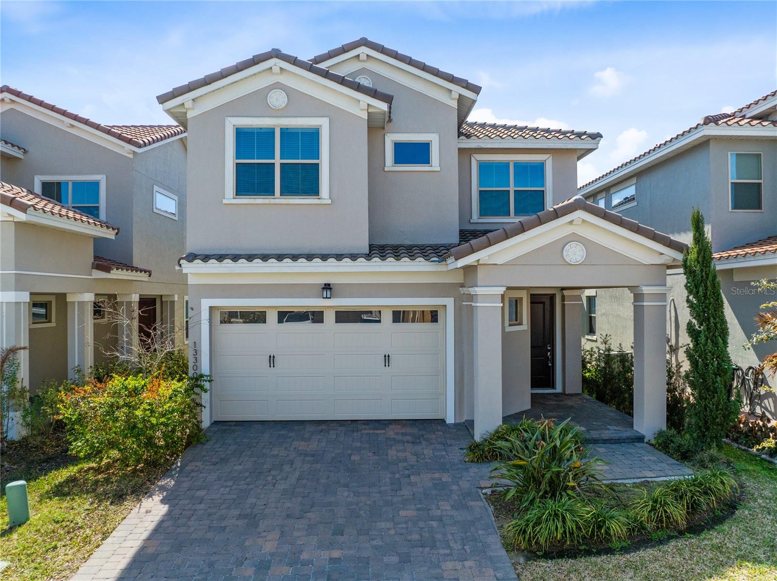 One or more photo(s) has been virtually staged. Welcome to this beautifully designed 2023 built home in the gated golf community of Eagle Creek. With a Mediterranean inspired elevation, tile roof, paver driveway, and covered front entry, this residence offers strong curb appeal and modern construction throughout. Spanning 3,180 square feet, the thoughtfully designed layout features five bedrooms, four and one half bathrooms, and flexible living space ideal for today’s lifestyle.The main level showcases an expansive open concept design finished with long plank ceramic tile flooring, crown molding, and recessed lighting. The living and dining areas flow seamlessly into a spacious kitchen designed for both everyday function and entertaining. Rich wood cabinetry pairs with quartz countertops, a large island with seating, built in double ovens, stainless steel appliances, a vented hood, and subway tile backsplash. The oversized island overlooks the main living space, creating a central gathering point for family and guests. Sliding glass doors lead to the covered patio and backyard, bringing in natural light and extending the living space outdoors.The first floor primary suite offers privacy and convenience, complete with tray ceiling detail, a spacious walk in closet, and a well appointed bath with tiled shower and double vanity. A highly functional design feature connects the primary closet directly to the laundry room, which includes a sink and additional cabinetry.Upstairs, a generous loft provides additional living space ideal for a media room, home office, or play area. The second floor also includes three additional bedrooms and two full bathrooms, along with a true second primary suite featuring its own private bath and closet, offering excellent flexibility for guests or multigenerational living.Built in 2023 with roof, AC, and water heater all from 2023, this home offers modern efficiency and peace of mind. Now vacant and move in ready.Residents of Eagle Creek enjoy access to a championship golf course, resort style pools, clubhouse with fitness center, tennis and basketball courts, playground, and Eagle Creek Elementary located within the community gates.