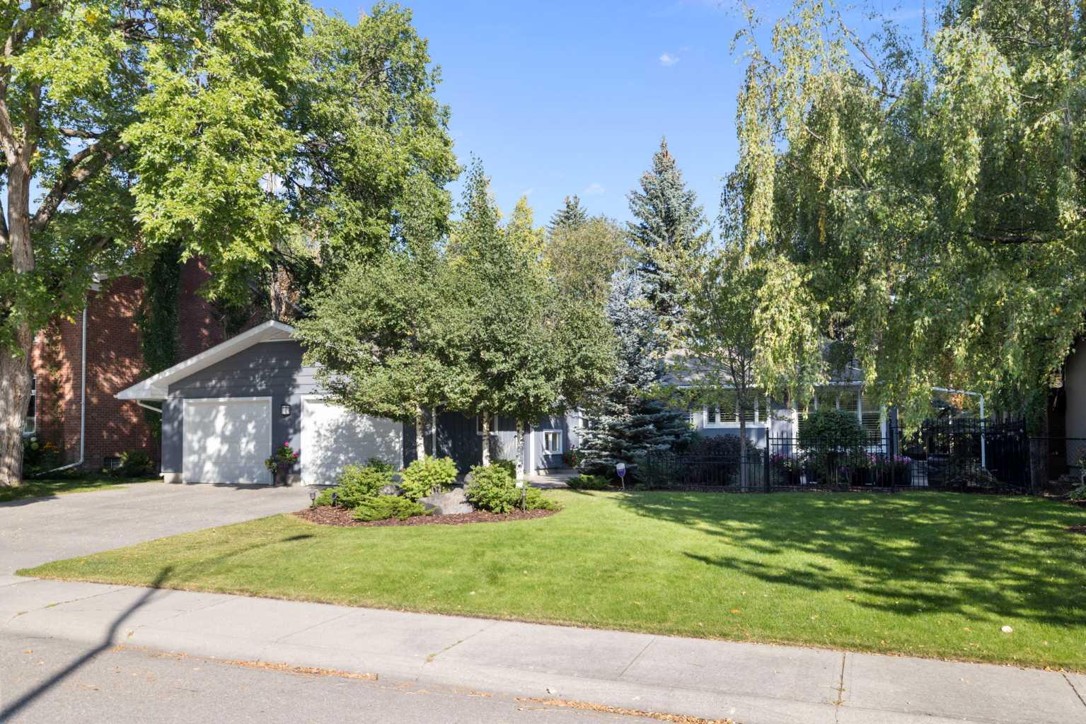 Welcome to this beautifully updated 5-bedroom, 4-level split home, offering over 3,300 sq. ft. of thoughtfully designed living space in Mayfair — one of Calgary’s most beloved and family-friendly communities.  From the moment you step into the inviting front courtyard, you’ll feel the warmth and character that make this home truly special. Set on a meticulously landscaped lot, the property showcases more than $150,000 in recent upgrades, including an exposed aggregate driveway, walkways, and patio, a freshly painted exterior, a striking new front door with glass side panels, and a fully renovated lower level with enlarged windows. Every detail reflects pride of ownership and a commitment to both comfort and style. Inside, a spacious foyer welcomes you into a light-filled living room with a wood-burning fireplace and expansive picture windows overlooking the private backyard — the perfect backdrop for family gatherings or quiet evenings at home. The formal dining room flows into a bright, renovated kitchen featuring granite countertops, timeless cabinetry, and ample workspace — ideal for both everyday meals and entertaining. Upstairs, the generous primary suite offers excellent closet space and a private ensuite. Two additional bedrooms and a full bathroom provide versatility for children’s rooms, guest space, or a home office. The lower level is a standout, with a spacious family/media room anchored by a second wood-burning fireplace. This cozy retreat is perfect for movie nights, games, or a teen hangout. A fourth bedroom, full bath, and laundry area complete this level.
The fully renovated basement offers remarkable flexibility: with a large bedroom, living area, oversized windows, and a 3-piece marble bathroom, it’s ideally suited for a nanny suite, in-laws, or university-aged children who want independence while staying close to home. Additional highlights include central air conditioning, newer furnaces, a new garage man door and opener, a garden shed, sprinkler system (front and back), and more — ensuring comfort and peace of mind for years to come. Outdoors, the private backyard is designed for both relaxation and play, offering space for kids, summer barbecues, and quiet moments in nature. All this is set within steps of a playground, just minutes from Britannia Plaza, Chinook Centre, and Calgary’s downtown core. Surrounded by excellent schools, scenic parks, and community spirit, this home is ready to grow with your family in one of the city’s most enduring neighbourhoods.
