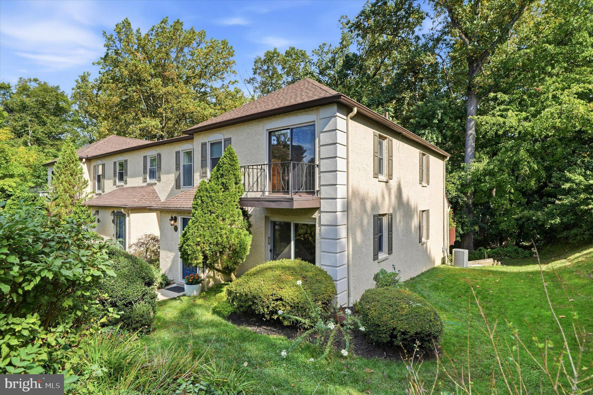 Welcome to 17 Summit Drive, a spacious end-unit townhome in the beautiful Mill Ridge community, located in the highly regarded Radnor Township School District. With neutral finishes, real hardwood floors, a recently finished lower level and wonderful indoor-outdoor living spaces, this home offers comfort, flexibility and an exceptional Main Line location.Step inside through the foyer with a double coat closet and continue into the living room, where sliding glass doors bring in natural light. The living room opens to the dining room, creating an easy flow for everyday living and entertaining. A convenient powder room features a tile floor and pedestal sink.The kitchen offers white paneled cabinetry, a stainless steel sink, electric range, large refrigerator, dishwasher and space-saving built-in microwave. An adjoining eating area features triple sliding glass doors opening to the rear deck, while the kitchen flows into the family room accented by crown and dentil molding.Upstairs, a spacious hallway includes the convenience of a washer and dryer. The generously sized primary bedroom offers two double closets and access to a Jack-and-Jill bathroom with a large vanity and linen closet. The adjoining guest bedroom features a large closet and sliding glass doors opening to a private balcony.The recently finished lower level adds valuable flexible living space with wood-look luxury vinyl plank flooring, recessed lighting, a large closet and sliding glass doors providing direct access outside. Currently used as an additional bedroom, this bright space could easily accommodate a home office, recreation room, fitness area or guest space. An unfinished portion of the lower level provides plenty of additional storage.Mill Ridge is known for its beautiful setting and distinctive amenities. Residents enjoy access to the community's historic manor house for social gatherings, private guest suites available for overnight visitors for a nominal fee, and a heated swimming pool with a fully equipped pool house.All of this is just minutes from Main Line shopping, restaurants, major roadways and everything Bryn Mawr has to offer. Enjoy the space of a townhome, the amenities of an established community and a sought-after Radnor Township location—all at 17 Summit Drive.