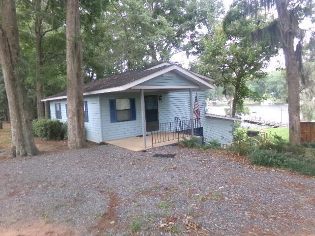 Wake up every morning to a gorgeous view of the lake right from your master bedroom with this waterfront home! Located on Lake Blackshear right next to one of the best spots to enjoy food and drinks on the water, Booger Bottoms! Nestled on a little over an acre of land, this retreat offers a private dock, ideal for boating and fishing, and breathtaking views which you can enjoy from the spacious back deck! Don't miss your chance to enjoy lakeside living! Call today for a showing!