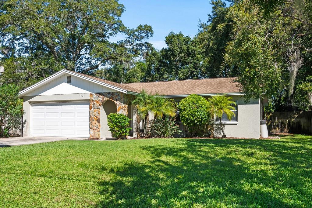 One or more photo(s) has been virtually staged. This is the one you've been waiting for!  Discover the perfect blend of modern updates and prime location in this stunning 4-bedroom, 2-bathroom Ranch style family home.  Nestled in the sought-after golf cart community of downtown Palm Harbor, this property is completely turn-key and ready for you to move in and start living the Florida dream. No Homeowner Association or HOA fees ever! Step inside to find gorgeous new tile flooring that flows throughout. You are greeted by a large front living room which opens to the dining room, complete with built-ins for your treasures and trinkets to display. The heart of the home is the beautifully updated kitchen (2020), featuring a long breakfast bar to showcase the gorgeous granite surface. Newer stainless steel appliances and a pantry round out the kitchen, which opens to the family room where double French doors lead out to the screened and covered patio. Peace of mind comes standard with major systems recently updated, including a newer roof (2019), a newer HVAC system (2019), and a brand-new water heater (2025).

The larger fourth bedroom will open your mind to possibilities—an office, playroom, workout space, or private retreat. It’s certainly large enough to capture your ideas about having that 'extra' space you've always needed.
Outside, the large, open, and fully fenced-in yard is a private oasis ready for all of your family activities. Imagine a chicken coop, raised bed planters, a child's playground, or a trampoline—the possibilities are endless, and there's still plenty of room to add the custom pool you've always wanted! This property is designated non-flood and sits on a generous lot, with approximate dimensions of 73 ft by 132 ft. It's always about location, location, location. This house is zoned for  3 of Pinellas County's renowned A-rated schools, including the highly-desirable Palm Harbor University High School. Living here means you're just a short walk or golf cart ride away from the vibrant shops, restaurants, and breweries of historic downtown Palm Harbor. You'll also be conveniently close to the beautiful downtown areas of Dunedin and Tarpon Springs, as well as pristine beaches, marinas, golf courses and bike trails. Whether it's biking, boating, or bird watching, this property offers a great opportunity for a full life in Pinellas County. Major league sport teams, colleges, and concert venues are worth noting. 2 major airports serve the area. 
Key Features:

4 Bedrooms, 2 Bathrooms

1,781 sqft of Living Space

Living Room, Dining Room & Family Room

New Tile Flooring Throughout

Updated Kitchen (2020) with Granite Countertops

Newer Roof (2019) & HVAC (2019)

New Water Heater (2025)

Newer Washer/Dryer (2019) Included

2-Car Attached Garage

Screened & Covered Patio

No HOA Fees

Don't miss this rare opportunity to own a piece of paradise with major updates already done for you. This home truly has it all!

Schedule your private tour today!