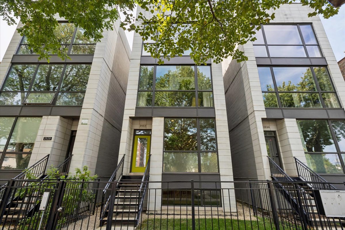 Welcome to this impeccably designed 3 bedroom, 2.5 bathroom duplex down condo located in an intimate 2-unit building, just steps from the heart of Logan Square. Offering over 2,400 square feet of thoughtfully curated living space, this home blends modern design with exceptional functionality. The main level is flooded with natural light thanks to east facing floor-to-ceiling windows and features an open-concept living and dining area - perfect for entertaining. The sleek, contemporary kitchen is a true showstopper, featuring two-tone flat-panel cabinetry, quartz countertops, Bosch stainless steel appliances, an exterior-vented hood, and a large peninsula island with seating. Down the hall, you'll find a spacious pantry/coat closet, a chic powder room, and a serene primary suite boasting a professionally organized walk-in closet and a spa-like ensuite bathroom with floating dual vanity, soaking tub, and separate glass-enclosed shower. The carpeted lower level offers soaring 10-foot ceilings and a massive family room complete with a wet bar and beverage fridge - ideal for movie nights or hosting guests. Two generously sized bedrooms (one with a built-in Murphy bed), a full bathroom, a large laundry closet with side-by-side washer/dryer, and two additional storage closets complete this level. Enjoy the outdoors with two private spaces: a cozy covered rear deck and an expansive 400 sq ft garage roof deck with newer Trex decking - perfect for entertaining or relaxing. Garage parking is included. Additional highlights include: 8' solid core doors, hardwood flooring on the main level, professionally organized closets throughout, incredible location just minutes from Logan Square's best dining, shopping, parks, and Blue Line This move-in ready home offers the perfect blend of style, space, and location.