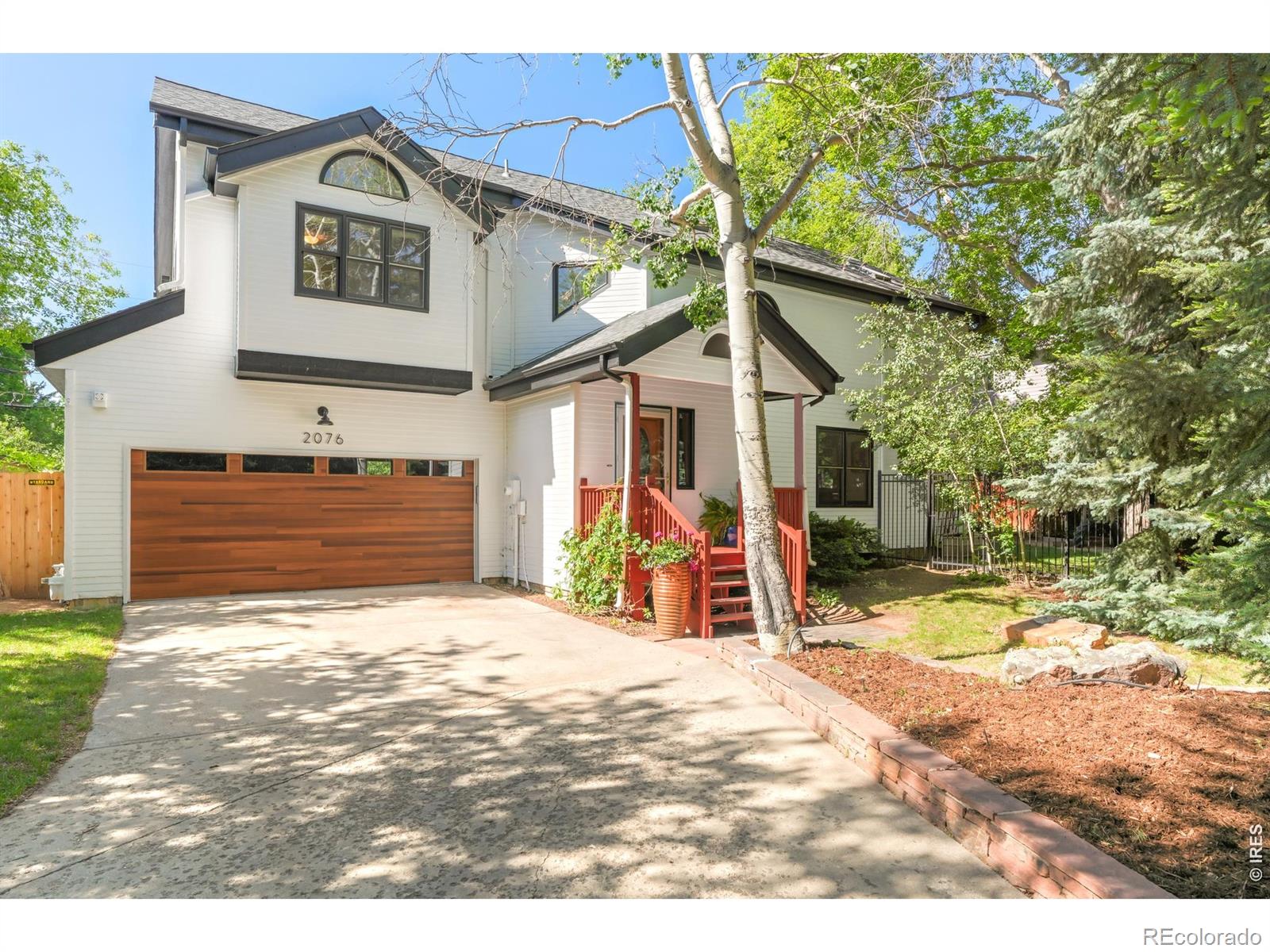 Tucked back from the street on a mature, fenced lot, this inviting North Boulder residence offers a thoughtfully designed floorplan in a sought-after location. Southern exposure fills the interiors with warmth, highlighting the dramatic double-height living room. The eat-in kitchen with granite countertops and stainless appliances flows into a formal dining area with direct access to a covered back deck overlooking the beautifully landscaped yard. Upstairs, the serene primary suite features treetop views,a large south deck, walk-in closet and an updated five-piece bath, complemented by two additional bedrooms and a shared bath. The finished basement provides remarkable versatility with generous flex space, a pocket door for guest quarters, a full bath and storage. Additional highlights include a main-level powder room, oversized attached two-car garage and proximity to Crestview Elementary and Centennial Middle schools, Lucky's Market, local cafes, dining and Boulder's extensive trail and bike path network.