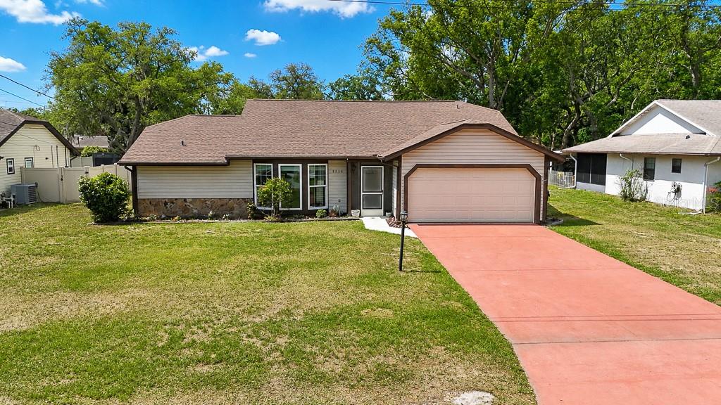 Welcome home to this beautifully updated 2-bedroom, 2-bathroom pool home with a 2-car garage, situated on nearly ¼ acre with no HOA and no CDD! This move-in ready property offers peace of mind with major updates including a new roof in 2024 with a transferable 10-year warranty, new windows in 2021, and a new septic system in 2023. Step inside to a spacious family room featuring sliding glass doors that open to the screened lanai and sparkling pool area. Just off the family room is a cozy breakfast nook overlooking the gorgeous kitchen, complete with shaker cabinets, breakfast bar, pass-through window to the lanai, and brand-new appliances including refrigerator, dishwasher, and stove all installed in 2024 — perfect for entertaining! The separate living / dining room combo is filled with natural light, creating a warm and inviting atmosphere throughout the home. The desirable split-bedroom floor plan provides privacy for both bedrooms and bathrooms. The owner’s suite features a walk-in closet, private slider access to the lanai/pool, and a remodeled ensuite bathroom. Outside, enjoy your oversized backyard, screened pool area, covered under-roof entertainment and dining space, and charming screened front porch. Easy-to-maintain vinyl siding adds to the home’s appeal. Conveniently located near US-19, shopping, restaurants, and entertainment. Don’t miss your opportunity to own this incredible home — schedule your private showing today!