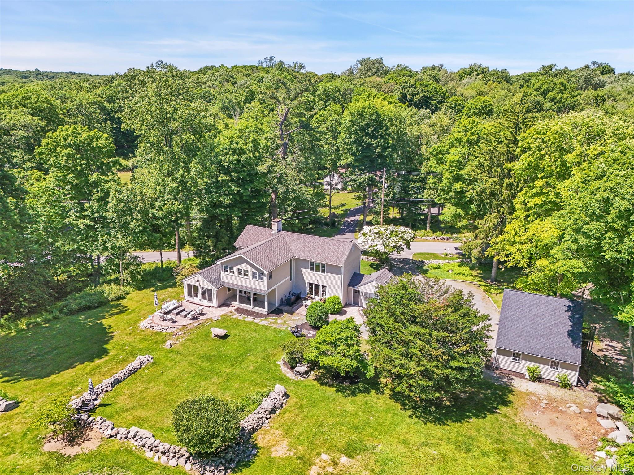 HIDEOUT HILL. Part of South Salem’s rich history. Circa 1740 Antique Colonial and one of the area’s oldest homes. Brimming with period details including wide board floors, two fireplaces and period moldings. Tastefully renovated in 2020 carefully marrying the old with the new. 3200 square feet of living space with beautifully proportioned rooms rich in detailing. Exceptionally appointed interior spaces with fine wall coverings, lacquer finishes and designer fixtures. Living and Music Rooms both with antique floors, exposed beams, built-ins and decorative fireplaces. Gorgeous new Kitchen with vaulted, skylit ceiling, custom cabinetry, leathered granite counters, a subway tile back splash and a center island. Open Dining Area with doors to rear terrace for easy indoor-outdoor entertaining. Beautifully appointed and spacious Family Room. Fabulous Sunroom with vaulted ceiling, sink and window seat. Private Primary Suite with timeless marble Bath. Two additional Bedrooms plus Office/Nursery. Peaceful and private two-acre setting. Pastoral landscape with old stone walls, level lawns, mature trees, flowering plantings and small stream. Detached Garage with large Walk-up Storage Loft. New, heated 12x16 structure – the perfect home office. Conveniently located with easy access to Ridgefield, Wilton, New Canaan, the train and commuting arteries. Fabulous!