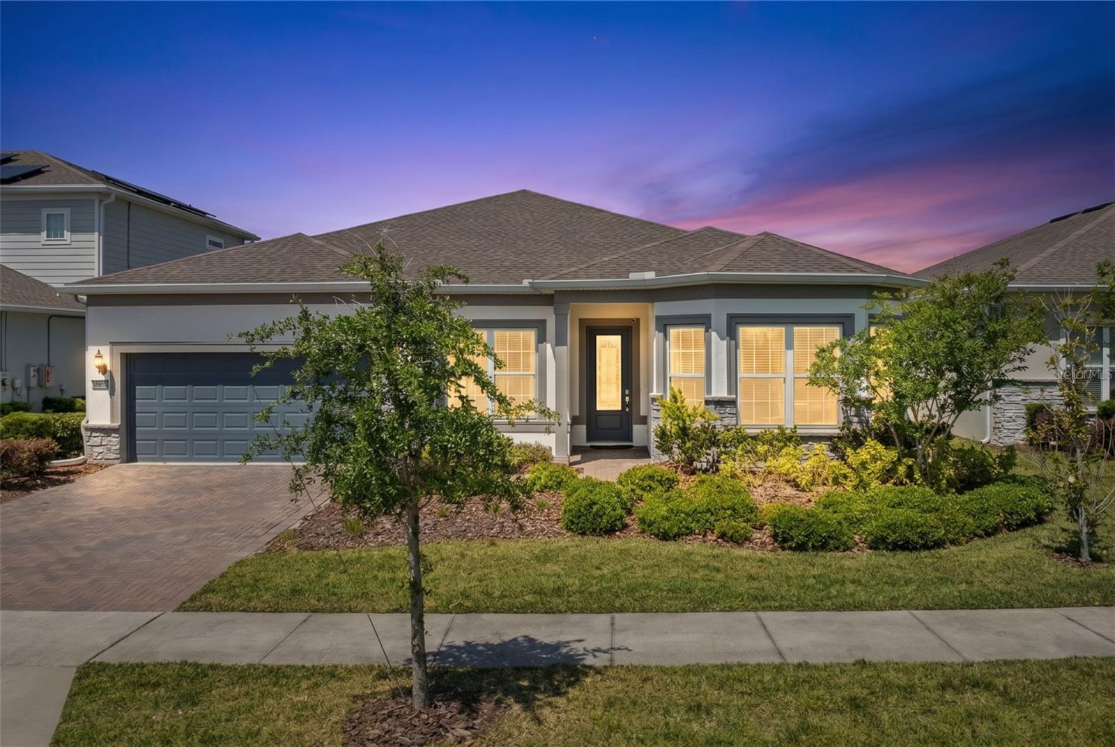 Welcome to resort-style living in the gated community of Isles of Lake Nona. Built in 2021, this stunning 4-bedroom, 3.5-bath residence blends modern elegance, thoughtful design, and tranquil waterfront surroundings to create an exceptional living experience in one of Central Florida’s most sought-after communities.From the moment you enter, the home impresses with its bright open-concept layout, expansive living spaces, and seamless indoor-outdoor flow. Large-format porcelain tile flooring, soaring ceilings, and oversized pocket sliding glass doors fill the home with natural light while perfectly framing the peaceful pond views from the main living areas.At the heart of the home is a beautifully designed gourmet kitchen featuring quartz countertops, espresso cabinetry with crown molding, mosaic backsplash, built-in oven and microwave, natural gas cooktop, Samsung smart refrigerator, under-cabinet lighting, and an oversized island ideal for entertaining and everyday living.The outdoor living experience truly sets this property apart. Step outside to your covered lanai and private waterfront retreat featuring a custom infinity-edge sea salt spa, brick paver patio, fenced backyard, and serene water views — creating an atmosphere that feels more like a private resort escape than a traditional backyard setting.The primary suite serves as a peaceful retreat with tray ceilings, power shades, private patio access, spacious walk-in closet, and a spa-inspired bathroom complete with extended quartz vanity, oversized shower, and abundant natural light.Additional highlights include a flexible split-bedroom layout, surround sound prewiring with installed speakers, fiber optic internet, smart home capabilities, natural gas community, spacious laundry area, drop zone, generous storage, and a 2-car garage with brick paver driveway.Residents of Isles of Lake Nona enjoy access to exceptional resort-style amenities including a clubhouse, fitness center, pool and splash pad, tennis, basketball, pickleball courts, playgrounds, walking paths, and gated entry.Ideally located just minutes from Lake Nona Town Center, Medical City, Boxi Park, Drive Shack, Orlando International Airport, and major highways, this home offers the perfect blend of comfort, sophistication, and luxury lifestyle living in the heart of Lake Nona.Lake Nona is more than a location — it’s a lifestyle. And this home delivers the experience buyers are searching for.