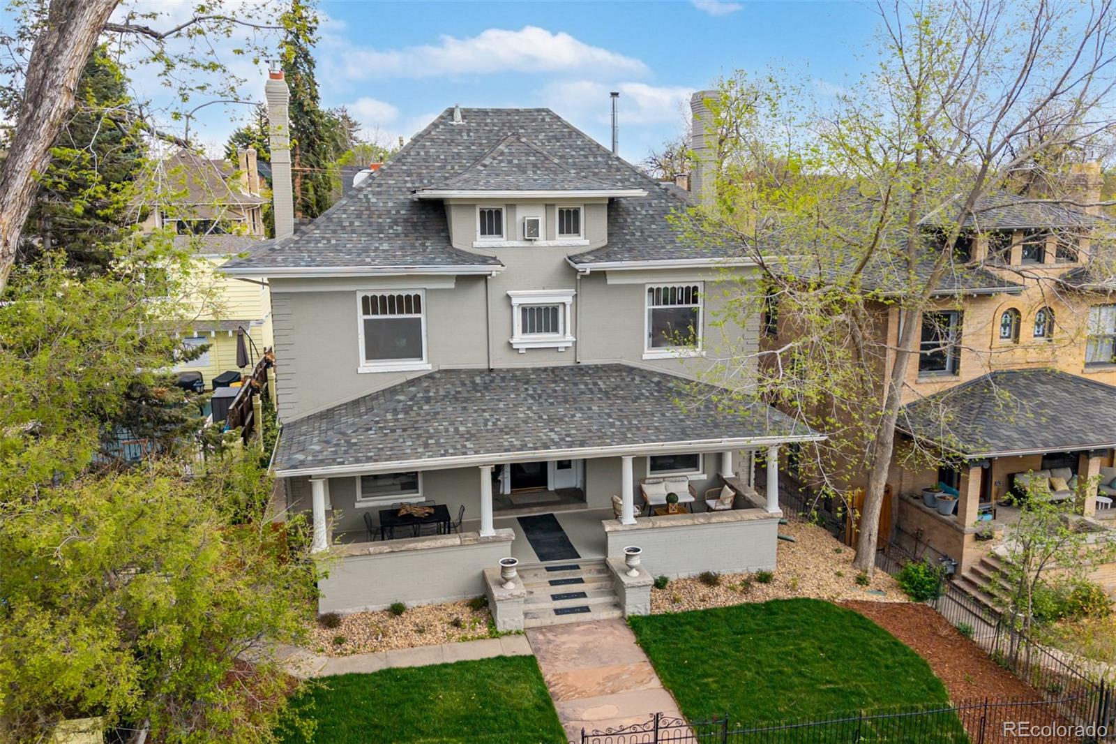 Welcome to this stunning 5-bedroom, 5-bath historic residence offering 4,641 finished sq ft in the heart of Denver’s coveted Historic 7th Avenue neighborhood.  From the moment you arrive, the expansive covered front porch sets the tone for timeless charm and inviting curb appeal. Inside, beautifully refinished wood floors, elegant moldings, and abundant natural light create a warm, sophisticated atmosphere. Thoughtful updates enhance the main level, improving flow between the kitchen and dining areas for more functional everyday living and effortless entertaining. The remodeled kitchen features custom cabinetry, stone countertops, a designer backsplash, and updated windows. The main level offers multiple living spaces, including a formal living room with fireplace, bright sitting area, dedicated dining room, and private office. Upstairs, the second level includes three spacious bedrooms, including a reimagined primary suite with a custom bath, custom closet and integrated laundry - an exceptional upgrade for a historic home.  Go up a "magic staircase" to a finished attic level with bathroom and closet providing a flexible space for guests, work, storage or hobbies. The finished basement with private entrance expands living options with an additional bedroom, full bath, and family room. Major upgrades include updated electrical, two high-efficiency Carrier furnaces with smart thermostat, and serviced evaporative cooler. The seller completed over $500k of remodeling.  There are no projects left! Additional highlights include a detached 3-car garage, custom deck, and refreshed landscaping with irrigation. Located just moments from Cheesman Park, Cherry Creek dining and shopping.  This home offers a rare opportunity to enjoy classic architecture paired with modern comfort in one of Denver’s most iconic neighborhoods.