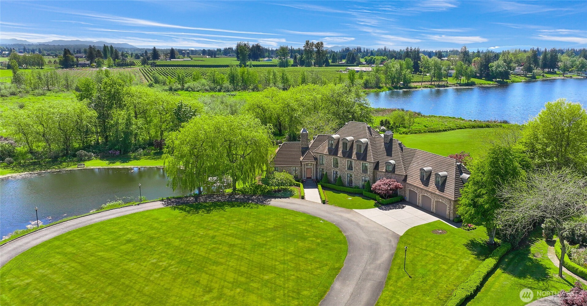 Rarely does the world of opulence so harmoniously blend with comfort of everyday living, offering a space that is both luxuriously appealing yet gives you that true feeling of being home. Superb craftsmanship & incredible spaces for gathering are the hallmarks of this 7,000 square foot French Country estate on over 10 acres at the end of a private lane. Enjoy a spectacular primary bedroom with a fireplace and two walk in closets, all bedrooms with en suite baths, and a one bedroom mother-in-law suite with its own private entrance. Wake up to epic sunrises on Mt.Baker while sipping your coffee and relax in the evening with a glass of wine watching the sun set over picturesque Wiser Lake. A legacy property, truly in a category of its own.