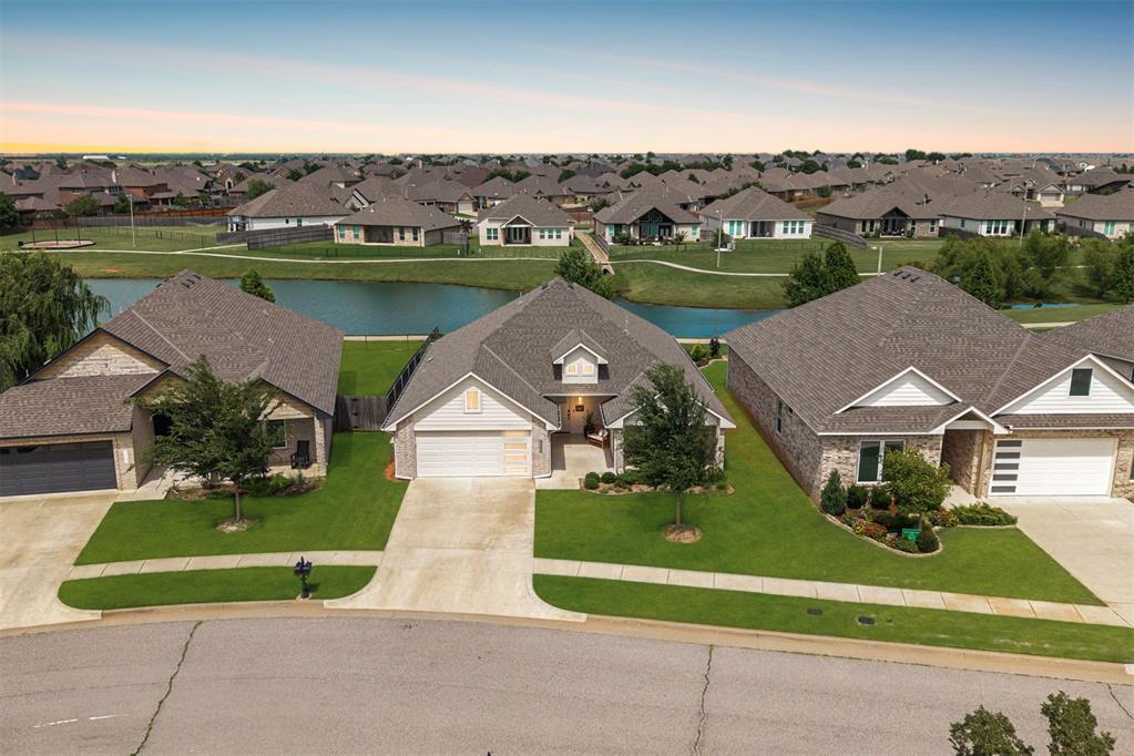 Welcome to 6209 NW 158th Street, where thoughtful design meets effortless living in the sought-after Deer Creek Park community—backing to a tranquil HOA fishing pond. From its simply elegant style to the inviting outdoor spaces, this home offers the perfect setting for a variety of lifestyles. Enjoy peaceful water views and unwind by your outdoor fireplace, creating a serene backdrop for both quiet evenings and lively gatherings. At the heart of the home, the spacious great room flows seamlessly into an open-concept kitchen—an entertainer’s dream. This beautifully designed kitchen is loaded with features: quartz countertops, stainless steel appliances, under-cabinet lighting, a sleek touch faucet, pull-out drawers in the lower cabinets, and a walk-in pantry to keep everything within easy reach. The primary suite is a true retreat, featuring a luxurious bath and a well-appointed walk-in closet. Generously sized secondary bedrooms ensure space for everyone. Additional upgrades include plantation shutters in all bedrooms, custom window treatments in the living area, an Alco security system, an in-ground storm shelter, and wall-mounted garage shelving for added convenience. Deer Creek Park offers a lifestyle that blends comfort with community—residents enjoy access to a neighborhood pool, walking trails, and a playground, all just steps from home. Plus, with easy access to the Turnpike, shopping, and dining, you'll love the convenience just as much as the charm. Don't miss your chance to call this one home. Welcome to Deer Creek Park!