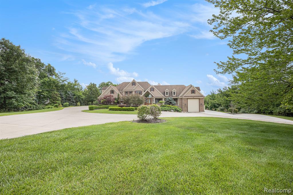 This truly magnificent lakefront retreat is nestled within the exclusive Lake Nepessing Bluffs. Situated on over 7 meticulously landscaped acres in a private gated community, this custom-built estate offers the pinnacle of luxury lakefront living. From the moment you enter the community, you’re greeted by a serene park-like setting, winding through rolling hills to a grand bluff-top residence with commanding views of all-sports Lake Nepessing. This stunning home boasts 8,987 sq ft of finished living space, with expansive windows that frame panoramic lake views from nearly every room. The main-level includes great room with soaring two-story ceilings and a statement fireplace, complemented by a lofted overlook. The gourmet kitchen is outfitted with high-end, energy-efficient appliances and flows seamlessly into both formal and casual dining spaces. A luxurious main-floor primary suite features a private fireplace, spa-like bathroom, and lakefront views. The finished walkout lower level is a true entertainer’s paradise, complete with a full second kitchen and bar, billiards room, home theater, dry sauna, steam shower, and additional laundry area. Outdoor amenities are just as impressive. Over 1,000 sq ft of low-maintenance paver patios and decks offer multiple spaces to relax and take in the views. A paved path leads to your private waterfront entertainment lounge which is equipped with overhead doors, heating, air conditioning, water service, and restrooms—ideal for lakeside gatherings. Enjoy private lake frontage and your own dock. Car enthusiasts will appreciate the oversized four-car garage, plus a heated 24’x50’ RV garage for additional storage. Whether you’re seeking a year-round residence or a luxury getaway, this one-of-a-kind estate offers unmatched privacy, craftsmanship and recreational opportunity.