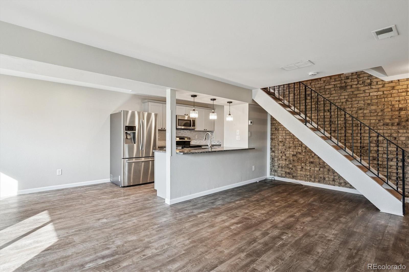 This delightful, well-maintained 2-bedroom, 1-bath condo in the Willow Park neighborhood, is ready for its new chapter. As you enter this inviting and fully updated home, you're greeted by a spacious open living room featuring an exposed brick wall, a dining area, and a nice kitchen with bar seating and well-proportioned spaces throughout. There is a full-size washer/dryer located in the kitchen as well.  Upstairs, you'll find a freshly remodeled full bathroom and two bedrooms, including the primary bedroom with a walk-in closet. The home boasts LVP flooring throughout the main floor and wood laminate flooring throughout the second level. There is a shared garage with some storage area - there is a new garage door being installed here soon. Step outside to enjoy the spacious community outdoor area, perfect for relaxing or enjoying fresh air. Conveniently located near Village Green Park, shopping centers, dining, the public library, and with easy access to I-225 and major highways for a quick commute to Downtown Denver and public transportation. This updated home offers comfort and convenience for any buyer and is a must-see!