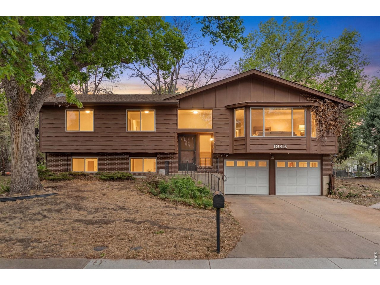 This spacious bi-level home on a large 0.24-acre lot offers flexibility & opportunity. Recent cosmetic improvements have already been started, including portions of flooring & interior paint, giving buyers the chance to continue adding their own style & finishing touches while building equity over time. Surrounded by mature trees, the property provides a peaceful setting with plenty of room to spread out both inside & out. Inside, the bright upper-level living room features a large bay window that fills the space with natural light & creates an inviting main gathering area. Hardwood flooring runs throughout the upper level, which includes 3 bedrooms & a full bathroom, while the primary bedroom overlooks the backyard. The kitchen & dining area flow directly to the covered back deck, creating an easy extension of the living area for outdoor dining, entertaining or enjoying Colorado evenings in a covered setting through multiple seasons. Downstairs, the lower level features a spacious secondary living area with a wood-burning fireplace, full bathroom, laundry room & additional bedroom, making the space flexible for guests, recreation, hobbies, work-from-home needs or a separate hangout area. Outside, the fully fenced backyard offers mature shade trees, a stone firepit area & abundant usable yard space with endless potential for gardening, pets, entertaining, recreation areas or creating your ideal outdoor retreat. Conveniently located near Cottonwood Lake/Park, dining, shopping & everyday conveniences along 23rd Ave, this property presents a great opportunity for buyers looking for character, flexibility & long-term potential.