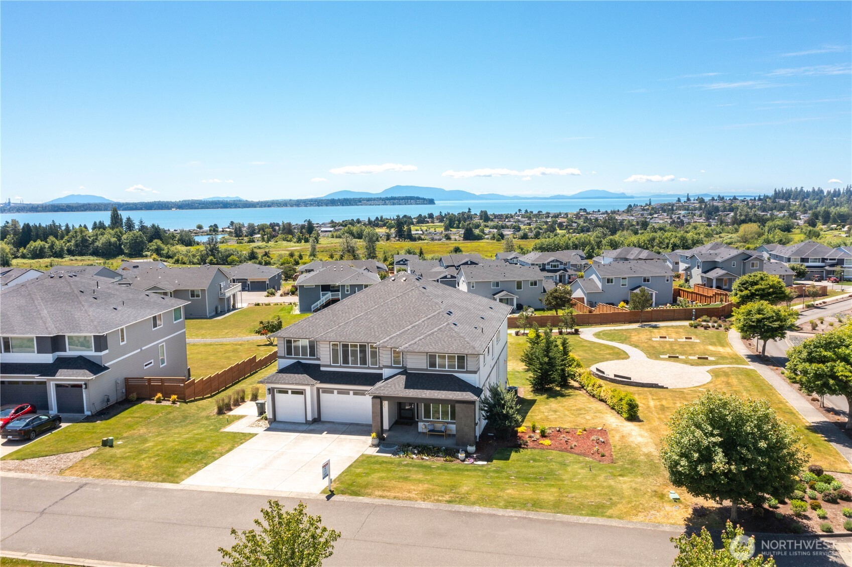 With a view that catches your eye as you merely drive by - this better than new fully upgraded and high-end appointed stunning home is available for new owners. Every space that matters is positioned perfectly to capture the peaceful pause mid-step view of Birch Bay, Mt. Baker & islands. Soaring two story foyer leads the way to expansive great room with continued soaring ceilings, spacious dining area and high-end chef's kitchen. Enjoy cozy evenings by the gas fireplace in the living room or head over to the great size den & enjoy a nice glass of wine. Gorgeous kitchen is heart of home with eat-in island, ample cabinets, stainless steel appliances, butler pantry plus huge walk-in pantry. Imagine prepping meals while gazing out at the bay, enjoying dinner on your custom trex deck with outdoor fireplace. Second level includes generous bay-facing owner's suite with even better vantage point, full ensuite bathroom & walk-in closet. 3 more bedrooms, laundry, 2 more bathrooms & large multi-purpose space fully utilize well-planned second level partially open to floor below.