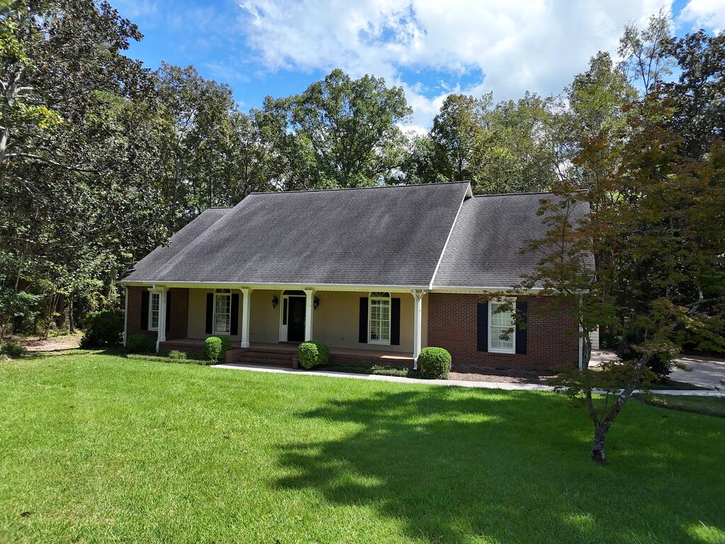 Located at 214 Yorkshire Crescent, this beautiful brick home offers comfortable lakeside living on 1.6 acres. Oak hardwood floors flow throughout the home, which features a welcoming foyer, a sitting room or home office, a formal dining room, and a spacious informal dining area. The living room is filled with natural light from large windows overlooking the patio and lake and includes a wood-burning fireplace for added warmth and character. The kitchen offers granite countertops, stainless steel appliances, a Sub-Zero refrigerator, wall oven, range, and dishwasher. The master suite features a beautifully remodeled bathroom with double vanities, a walk-in closet with built-ins, a freestanding tub, separate shower, and private water closet. Three additional bedrooms, two additional bathrooms, and a large laundry room provide plenty of space and functionality. Outside, enjoy the spacious patio and peaceful lake views. A two-car garage and separate storage room complete this inviting property. Click here for virtual tour: https://my.matterport.com/show/?m=MhPhm4yx5qm&mls=1