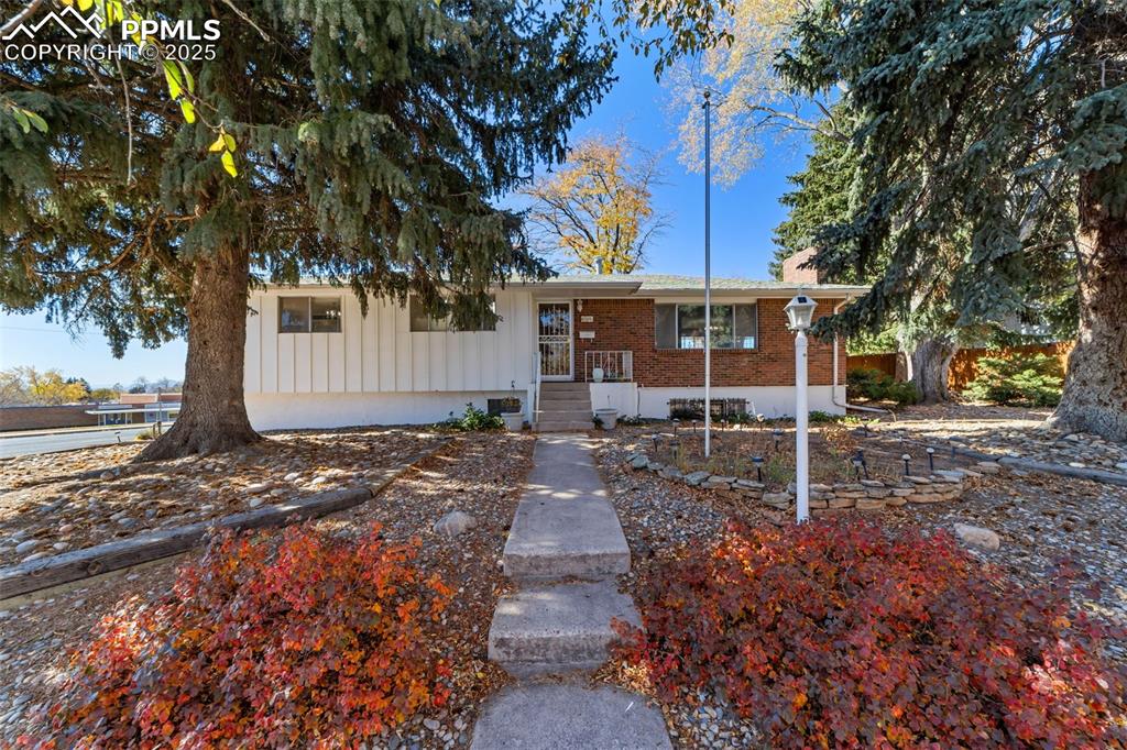 Welcome to this beautiful mid-century ranch nestled in the heart of Colorado Springs. Perfectly situated on a large lot with stunning mountain and Pikes Peak views, this home blends timeless character with modern comfort. Enjoy an unbeatable location—just a short walk to Palmer Park for hiking, mountain biking, and the dog park, as well as nearby schools. You can even take a quick golf cart ride to the Colorado Springs Country Club. Step inside to find brand-new luxury vinyl plank flooring and fresh interior paint that enhance the home’s warm, inviting atmosphere. The spacious main level features a huge family room centered around a classic wood-burning fireplace, a formal dining area, and a bright kitchen offering ample cabinet and counter space. The primary bedroom includes a private attached ¾ bathroom, while additional bedrooms provide flexibility for family, guests, or a home office. Downstairs, the basement offers a 4th bedroom, 3/4 bathroom and a large second family room with another cozy wood-burning fireplace—ideal for movie nights or entertaining. Original hardwood floors add a touch of mid-century charm, while thoughtful updates such as a new main electrical panel and central A/C ensure peace of mind and year-round comfort. Outside, the expansive yard provides plenty of room to relax, garden, or simply take in the incredible mountain backdrop. An oversized, heated two-car garage offers abundant storage and workspace for hobbies or outdoor gear. With its combination of classic design, modern updates, and prime central location, this property captures the very best of Colorado Springs living. Whether you’re drawn by the mountain views, outdoor recreation, or the vibrant local community, this is the perfect place to call home.