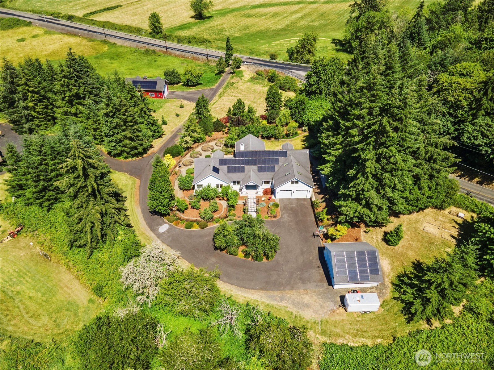 First time ever offered! Exceptional custom estate on 5 private acres bordering the Willapa Hills Trail, where hiking, biking and horseback riding begin at your doorstep—just minutes from downtown Chehalis, I-5, local museums and the athletic club. Designed for entertaining and effortless everyday living, this stunning 4BR, 3.75BA home showcases soaring 16' ceilings, walls of windows, natural stone flooring, granite countertops and expansive covered outdoor living. The luxurious main-level primary retreat features patio access, heated floors, a jetted tub, dual shower heads, walk-in closet and spa-inspired bath. Upstairs offers a spacious bonus room, bedroom and full bath—ideal for guests, multigenerational living or a private retreat. Outside, enjoy raised gardens with zoned irrigation, a fruit orchard, blueberry bushes, fenced backyard, custom sauna, winding wooded paths, detached garage, barn, RV parking and owned solar panels (2023). The home is generator-ready, with the main residence wired for a generator, 220 power available in both the attached garage and barn, and a detached garage already wired for future electrical connection. A rare opportunity to own an impeccably maintained legacy property where luxury, privacy and nature come together.