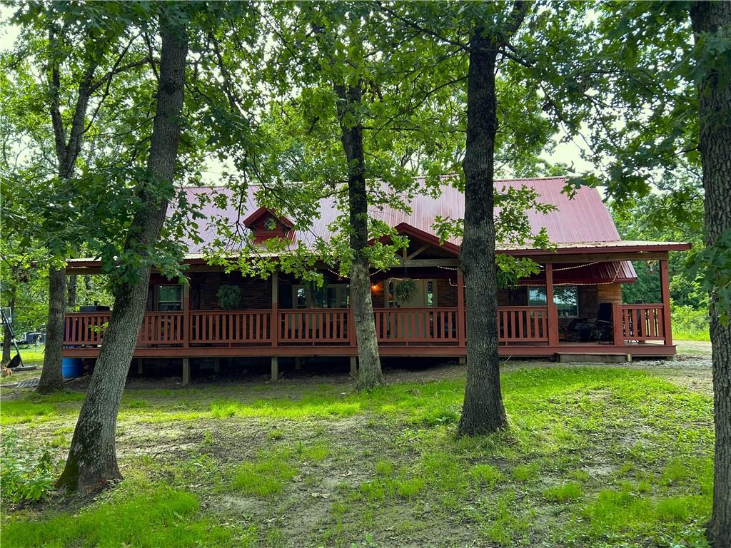 14.6 Acres nestled near the banks of the Osage Arm of the Truman lake, this stunning 2 Bedroom, 2 Bath home, along with Guest Quarters on the property, is truly a relaxing place of retreat! Enjoy the peace & quiet of the country with acres for horses, cattle & hobby farming, while having the room available to invite loved ones to visit & enjoy all this property & Truman lake has to offer. The home is @ 1.5 miles from the lake.  Ride your ATV, or take a morning walk to the water to throw in your fishing pole or jump in and enjoy a swim. The wooded area around the home provides an atmosphere of the Ozarks. The large covered front porch is the perfect nook to relax with your morning coffee while watching deer & turkey move throughout the property.  Enter the front door to the great room of the home to find beautiful ship lap wood vaulted & beamed ceilings throughout the main living space with wood plank flooring & a lovely brick hearth fireplace.  The open concept design brings family/friends together as the kitchen, dining & living space flows beautifully, providing country charm with updated, custom finishes throughout the home. The primary bedroom & bath lends to a relaxing retreat after a long day as you soak in the jetted tub or enjoy the oversized walk in shower. Step out the back door to find an insulated building with H&A, which is the perfect location to work from home with high speed internet avail & extra storage galore! Slightly west, you'll find guest quarters which has H&A, water & all that's needed. The 24x36 metal barn/garage with concrete floor & 200 amp elec is the ideal place for vehicles &/or boat storage & workshop. Additionally, there are 2 separate 55 amp plug ends for your RV. The property has trails for ATV/or horseback riding & is located @ 2.5 miles from the Osceola boat ramp. Enjoy hunting & fishing on the Corp land with recreation enjoyment year around. Home warranty. Begin now making lasting memories in this beautiful home!