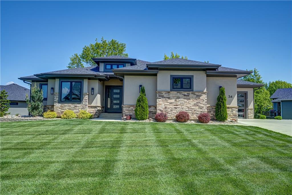 Better than new custom reverse 1.5 plan in Lake Winnebago backing to green space!  This is a 2nd tier home which comes with an assigned dock slip just a short walk or golf cart ride away.  Backing to trees and privacy, this well-crafted home has only been lightly lived in, and many upgrades added.  In addition to all of the original features of this home, upgrades include fenced back yard, epoxied garage floors, automatic blinds, screened in deck, whole home water softener, upgraded landscaping, and stairs off the deck.  The open concept main level has beautiful large windows with transoms allowing in so much natural light.  The wide-plank hardwood floors flow through the main living spaces and into the office/2nd bedroom.  This custom kitchen includes a 6-burner Cafe stove, large center island, quartz counter tops, soft-close drawers, and a walk-in hidden pantry with garage access for groceries.  The large primary suite on the main level includes access to the screened-in deck, vaulted ceiling, detailed trim wall, walk-in tiled shower, jetted tub, walk-in closet and connected laundry room!  Don't miss the additional laundry room in the basement for the additional 2 bedrooms, each with their own dedicated full bath.  Basement includes large daylight windows in all rooms, wet bar, media/entertainment area, and wine room.  Enjoy the quiet mornings and evenings on the screened in deck, overlooking one of the many greenspaces this community offers.  Double-sided fireplace is perfect for the indoor or outdoor space!  Oversized side-entry two car garage has painted walls, garage sink, and epoxy floors....connected to tandem front entry 3rd garage, long enough for a vehicle PLUS a golf cart, lawn mower, jet skis, or boat storage!   New community resort style pool with swim lanes is currently under construction, and will be a huge asset to the community soon. Vacation where you live, in Lake Winnebago!