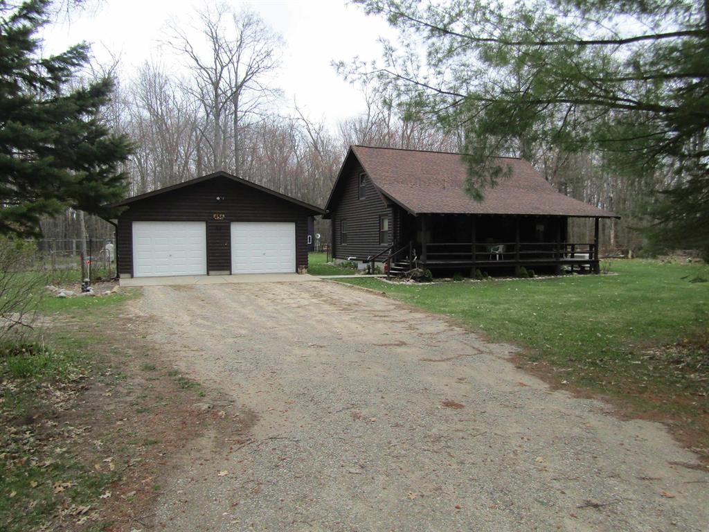 Experience true up-north living with this inviting 3-bedroom, 1-bath log home on ten private acres, surrounded by nature, quiet, and endless room to roam. Warm wood interiors and a classic cabin feel make the home comfortable year-round, whether youre settling in full-time or escaping for weekend retreats. Enjoy the large composite deck for entertaining or just being outside with nature. The property is set up for self-sufficient, practical living with a backup generator, a two-car detached garage, and two additional outbuildings for tools, equipment, or recreational gear. A fenced-in garden area is ready for growing your own produce, adding to the homestead appeal. What truly sets this property apart is its location. Youre close to thousands of acres of state land, offering unmatched access to hunting, hiking, and exploring. Outdoor enthusiasts will love the nearby riding trails for snowmobiles and ATVs, making this a perfect basecamp for year-round adventure. With acreage to enjoy, storage for all your toys, and direct access to Michigans great outdoors, this log home delivers the lifestyle so many buyers are searching for.