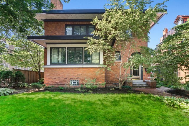 Discover this gorgeous extra-wide brick home on a premier tree lined cul-de-sac street in Sheridan Park.  The home sits on an estate-like 50x154 lot, complete with a beautifully landscaped front yard and a gracious formal foyer that preserves its original vintage details, such as stained glass windows and classic woodwork. The main level is designed for both comfort and entertaining. The professional kitchen features Thermador and Kitchenaid appliances and a large island with a breakfast bar that flows seamlessly into separate dining and family rooms. This level also includes a convenient covered side entrance and is serviced by dual-zoned HVAC for optimal climate control. The second floor features three bedrooms and two full bathrooms. The primary suite offers a roomy walk-in closet, a private roof deck, and a bathroom equipped with a steam shower. The radiant-heated lower level provides another full bathroom, laundry room, and potential for additional living space. Abundant storage and closet space are found throughout the home. Exterior amenities include multiple outdoor spaces, highlighted by a beautifully landscaped and irrigated backyard perfect for relaxation or gatherings. Parking is plentiful, with an oversized two-car garage that includes a large workshop and additional storage, plus an adjacent parking pad for a third vehicle. The location offers easy access to the lakefront, the Broadway entertainment district, and public transit.