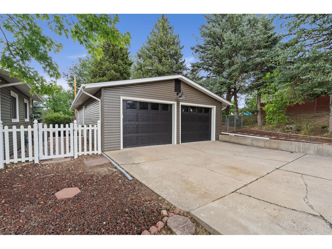 Far from ordinary. This iconic 1961 mid-century ranch in coveted Dean Acres is serving serious style. Set on a sprawling 1/3-acre corner lot, the freshly painted exterior showcases the home's clean architectural lines and timeless curb appeal. Inside, vaulted ceilings, exposed wood beams, oversized windows, and a statement fireplace celebrate its mid-century roots, while an open floor plan and beautifully updated kitchen bring the home effortlessly into today. Fresh interior paint, refinished hardwood floors, and updated lighting create a cohesive, designer-inspired feel throughout. The dreamy primary suite is its own private retreat, featuring a spa-worthy bath with floating vanities, radiant heated floors, a steam shower, and direct backyard access-perfect for adding the hot tub you've always wanted. Need flexibility? The walkout lower level delivers with a full second kitchen and endless possibilities. Create the ultimate guest quarters, multi-generational living space, income-producing rental, or the coolest hangout in town. Laundry rooms on both levels mean everyday convenience, no matter how you use the space. Outside, the lifestyle only gets better. Sip your morning coffee or unwind under the expansive covered deck while listening to the sounds of nature. Let the dog roam the spacious backyard, stash your gear in the storage shed, and spread out in the heated four-car garage with room for vehicles, projects, and all your toys.Tucked into one of Fort Collins' best-kept secrets, Dean Acres offers access to Lee Lake plus miles of nearby hiking and biking trails. Homes with this much personality, flexibility, and style don't come along often. This isn't just a house-it's a vibe.
