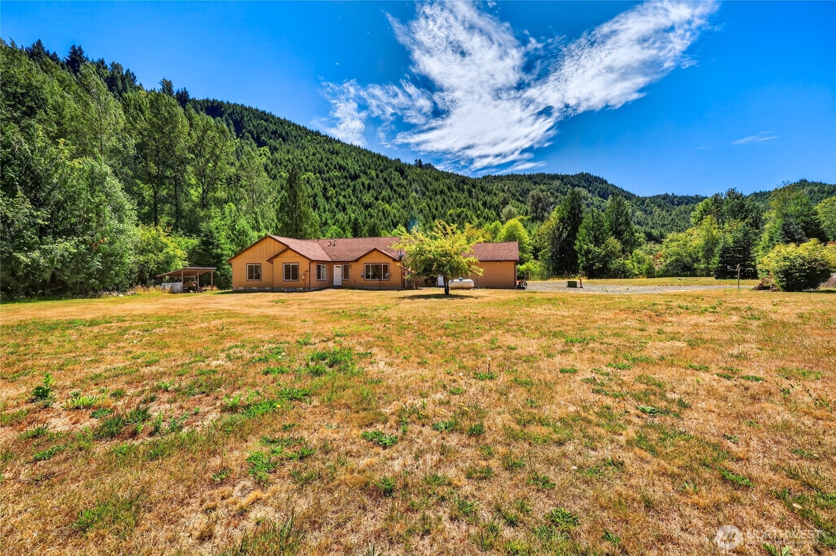 Move right in and enjoy peaceful country living on this beautifully maintained, flat 5 acre property in Glenoma. Built in 2012, this 2,200+ sqft home offers stunning territorial views and borders timber land for added privacy. Inside, you'll find a spacious primary bedroom with a walk-in closet and ensuite featuring dual sinks and ample storage. Office/ Den has relaxing views, yet provides pocket doors for those that may need to focus on their work. The well-appointed kitchen includes granite countertops, a large island, updated appliances, a conventional range, and a separate propane cooktop. The conveniently located utility room with a 3/4 bath is located just inside-perfect for those who don't want to track a mess through the house. With a heat pump providing efficient heating and A/C, plus the warmth of a wood stove, plan to stay comfortable year round, no matter the weather. Private well and septic help keep utility costs low. Outdoors lovers; stay home and enjoy the seasonal creek and established garden or head for the hills! Home is conveniently located a short jaunt to Gifford National Forest, Lake Scanewa, and Riffe Lake- or go a little further to enjoy Mt. Rainier National Park or White Pass Ski Resort. After a long day unwind on the large patio with hot tub and enjoy a home that's been exceptionally cared for and is truly move in ready.