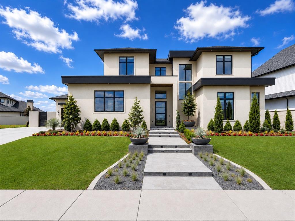 Experience exceptional contemporary luxury in this architecturally striking new home in Norman's premier gated community of Ashton Grove. Situated in The Villa's at Ashton Grove this lakefront home was built by Denali Homes offering a floor plan designed to fit whatever your lifestyle requires. Boasting 5 bedrooms with the primary suite plus 2 additional suites downstairs, one that could easily be used for a study.  2 additional bedroom suites up plus a huge bonus/media/rec room! Clean lines, soaring ceilings and abundance of natural light, this stunning home seamlessly blends sophisticated design with everyday livability! Showcasing hardwood floors, designer lighting, dramatic feature walls flanking the fireplace and expansive windows with motorized blinds, bringing in the impressive views in front and back! The kitchen features a dual fuel gas cooktop with double electric ovens, a subtle cabinet design built-in refrigerator and a butlers pantry with a closet doubling as a safe room/walk-in storm shelter! A backyard oasis includes outdoor living featuring motorized patio screens for everyday use, a fireplace, alfresco dining, built-in grill and relaxing pool with a waterfall and spa! The backyard offers additional space to play and is all turf for easy maintenance and year round beauty! A 3 car garage and expansive drive offers plenty of parking. This home offers all the incredible amenities with an easy maintenance lifestyle!