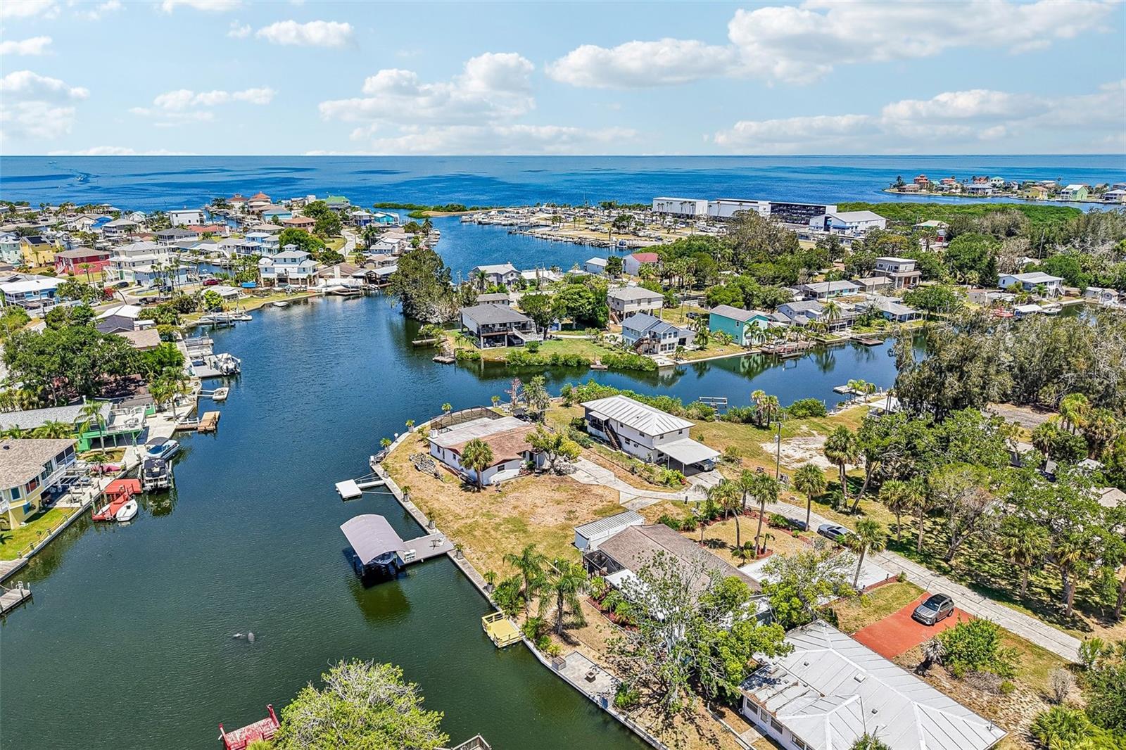 ++THE ULTIMATE BOATER’S PARADISE: Completely Remodeled with ZERO Bridges to the Gulf!Like NEW – 3 BR / 2 BA Waterfront Home with Private Dock.Welcome to your dream Florida getaway! This stunning, completely remodeled waterfront property offers the ultimate lifestyle for boaters, anglers, and water lovers. Situated on a premier deep-water canal, you enjoy DIRECT, unrestricted access to the Gulf of Mexico—meaning absolutely NO bridges to go under. Bring your sailboat or large watercraft, cruise out effortlessly, and enjoy an easy, bridge-free boat ride straight to the open water!++ Inside: Modern Luxury & Open-Concept Living:Step inside a home that looks and feels brand new, featuring stylish décor and a seamless layout designed for entertaining and relaxation.A bright, expansive living room and dining room combination that frames gorgeous views of your backyard oasis. To the left of the Florida room, a spacious screened-in lanai serves as the perfect transition to the waterfront yard. Features a dedicated, extra laundry room complete with a brand-new washer and dryer that convey with the home.  3 spacious bedrooms, 2 beautifully remodeled bathrooms, and all-new appliances throughout the kitchen.++ Outside: Your Private Key West-Style Oasis:The backyard is tailored for peak coastal relaxation, offering a distinct island vibe.Private Dock (Built 2023): Located on a deep-water canal with plenty of room to add a boat lift and jet ski lifts.Unwind at the end of the day on your dock and take in spectacular, unobstructed sunset views right from your private backyard.Professionally curated landscaping to give you that laid-back, vacation-every-day Key West feel.++ Turnkey & Worry-Free: Premium Upgrades:Every major component of this home has been updated for maximum efficiency and peace of mind:Completely Remodeled interior and exterior accents, New Gutter System (2025), Private Dock (2023), HVAC System (2019), Roof (2015)Energy-Efficient Florida Low-E double-pane windows & Newer Water Heater.++ Location, Location, Location!Nestled in a highly desirable, golf-cart-friendly community, you are seconds away from the best of the Gulf Coast:Boater’s Dream, as the home is located right next to Hudson Marina and minutes from local boat ramps.Cruise on your golf cart or take a short drive to the area's best waterfront dining, bait shops, marinas, beaches, grocery stores, and shopping.Whether you are looking for a high-performing vacation rental, a seasonal retreat, or your forever home, this waterfront gem is entirely move-in ready. Schedule your tour today before this bridge-free paradise sails away!