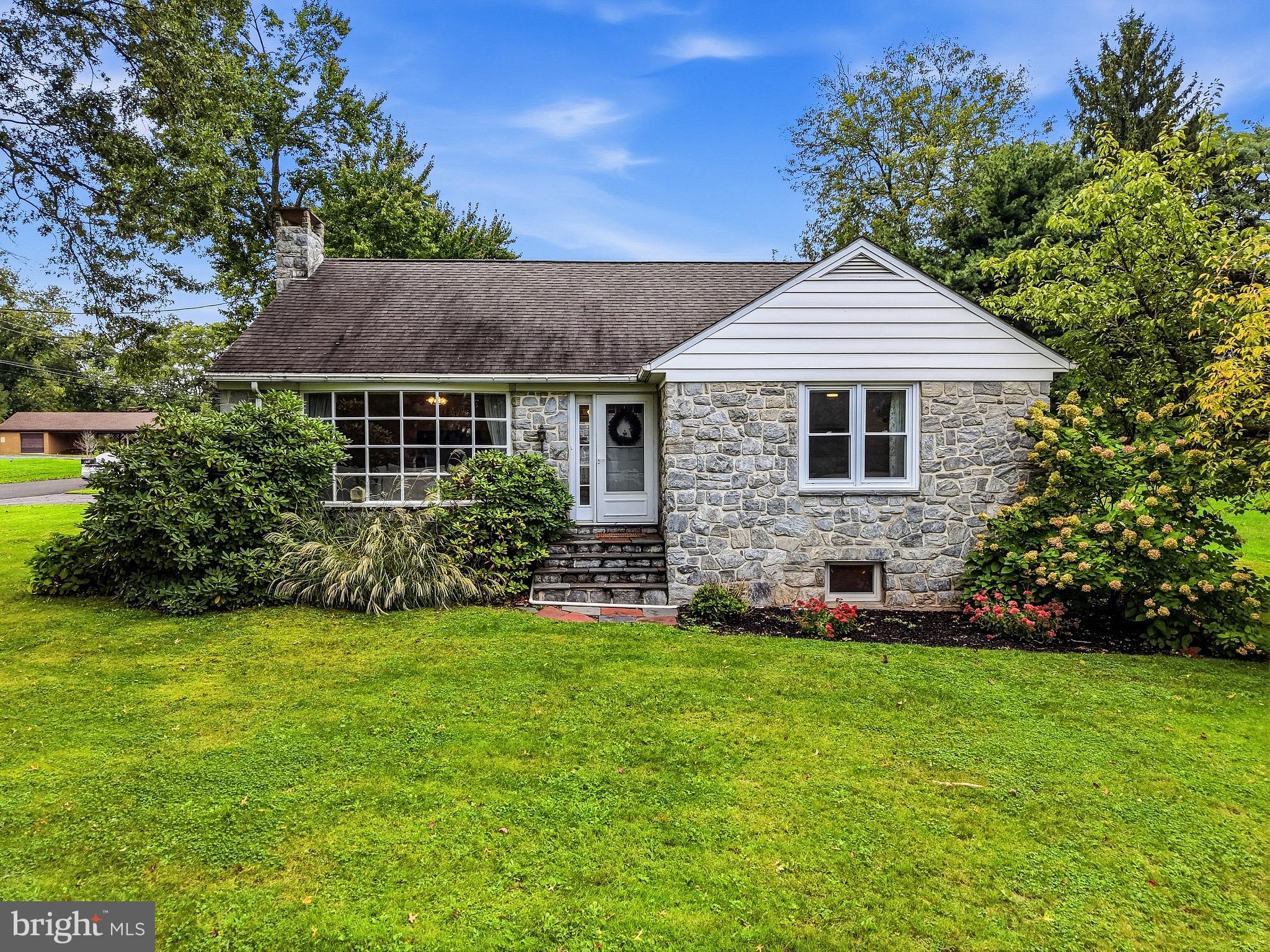 Storybook adorable and impeccably updated, this all-stone expandable ranch in the Owen J. Roberts School District is one of those houses that just makes you smile. With beautiful hardwood floors, a seriously pretty renovated kitchen, flexible living space, a fenced yard, and a cozy stone fireplace downstairs, there's a whole lot to love tucked inside this charming home.Step through the front door into the bright and welcoming living room, where a big bow window lets the sunshine pour in and golden oak hardwood floors add plenty of warmth and character. Just beyond is the beautifully renovated eat-in kitchen - and this one is a good one! Custom white soft-close cabinetry, tons of quartz countertop space, stainless steel appliances, a deep farmhouse sink, subway tile backsplash, and a cozy dining area make this a kitchen you'll actually want to hang out in.Off the kitchen is an adorable enclosed sunroom/breezeway with slate flooring that connects the house to the attached two-car garage and leads right out to the rear patio and fenced backyard. Morning coffee, a room full of plants, a comfy chair and a good book... this little space is just begging to be enjoyed.The main level offers two nicely sized bedrooms, both with hardwood floors and generous closet space. The 15'x12' primary bedroom has two double closets, while the second bedroom has a double closet of its own. They share a nicely updated hall bath with a tub surround and ceramic tile flooring.But wait - there’s more house hiding upstairs! A full staircase leads to the second floor, giving you the potential to create a third bedroom, home office, studio, or whatever extra space makes sense for you.Downstairs, the huge partially finished basement brings all kinds of cozy, slightly retro charm with real knotty pine paneling and a big stone wood-burning fireplace. It’s practically made for movie nights, football Sundays, game tables, or a really great hangout space. There's also a large storage and laundry room plus a super-convenient second full bath with a stall shower.Add in the central air, public sewer, attached two-car garage, mature landscaping, fenced backyard, rear patio, and that classic stone exterior, and you've got a home that manages to be charming, practical, flexible, and ridiculously cute all at the same time.