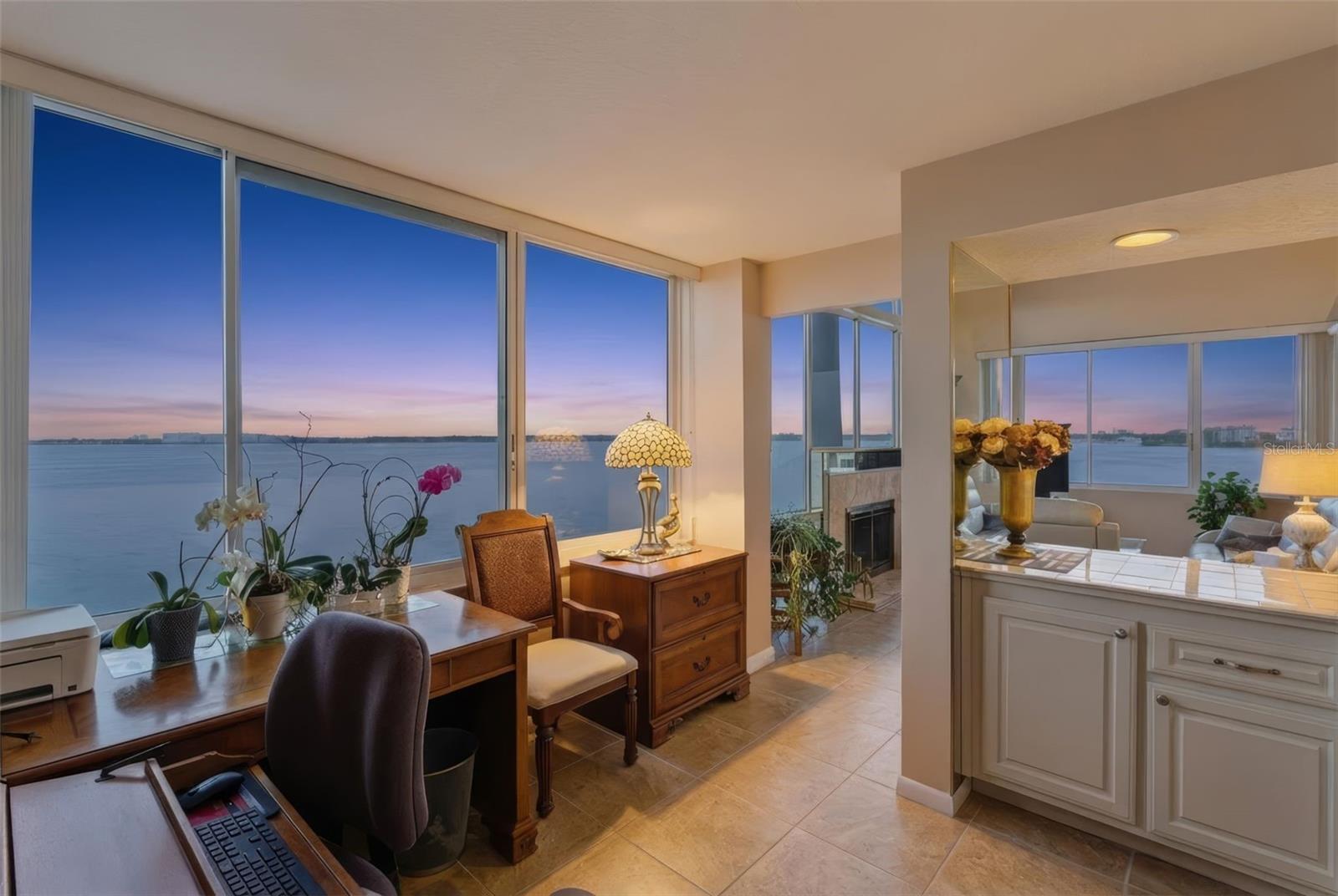 Offered for sale by its original owner, this unit presents a rare opportunity to own one of Isla Key’s most exceptional residences. This expansive corner penthouse is one of only four larger penthouse units in this community of 192 homes and is designed with architectural advantages that make this home incomparable to others at Isla Key.Extra-high ceilings and walls of glass create a sense of volume and light that immediately set this home apart. Positioned to capture sweeping, unobstructed views of Boca Ciega Bay, the outlook is nothing short of extraordinary.The scale of the view is matched by the number and size of the windows through which it’s enjoyed, offering a panoramic experience that is rare at any price point. Unlike typical floor plans, this residence features a true, generously sized office with large bay-facing windows, an inspiring space that elevates daily living and offers supreme work-from-home potential.The home also includes a wood-burning, marble-clad fireplace, adding warmth and character for those precious few chilly winter evenings, when the fire is framed by the lights stretching from St. Pete Beach to downtown St. Petersburg.Completely move-in ready and offered turn-key, the unit has been thoughtfully updated throughout. A brand-new kitchen showcases beautiful custom cabinetry and quartzite countertops, a material carried seamlessly into both bathrooms and even the sill of the large primary bedroom window, an attention to detail that underscores the quality of the renovation. The primary suite is further enhanced by new furniture and a custom-built closet system.The community of Isla Key, which features a recently completed seawall, is coveted not only because of its incredible waterfront location and expansive views, but also because of its amenities, including an exceptionally large heated waterside pool and spa, tennis and pickleball courts, bocce ball, and its convenience to both the vibrancy of downtown St. Petersburg and the white sands of the Gulf Beaches.For buyers who recognize that not all units and not all views are created equal, this penthouse represents something truly special.