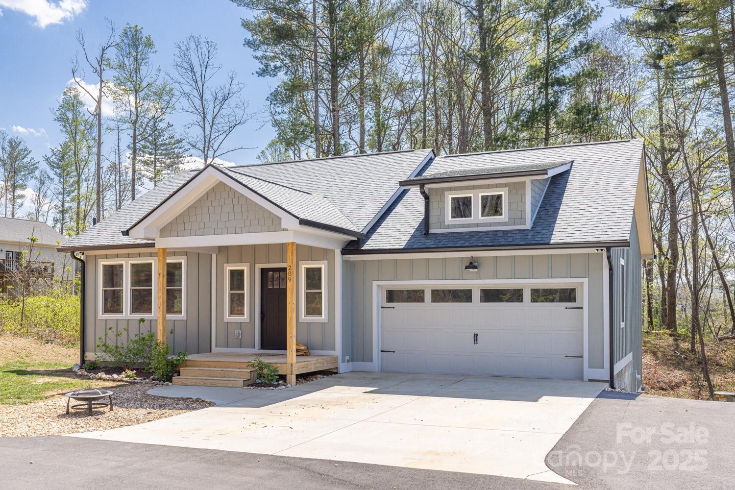 Fabulous Like-New Home in Fairview! This 3BR/2.5BA gem offers easy main-level living. Step into a warm entry & enjoy a stone fireplace under a tray ceiling in the spacious living room. The open floor plan connects the living, dining & a bright kitchen w/solid surface counters & dual pantries—ideal for any cook! The primary suite features a tray ceiling, custom wood-shelved walk-in closet & spa-like bath w/tiled dual-head shower & stone bench. Relax on the back deck w/peaceful wooded & mountain views on a .64-acre lot. The level-to-sloping backyard offers room to roam or play. The lower level includes 2 bedrooms, a family room, desk nook & full bath, plus unfinished storage/workshop space. Endless hot water w/tankless water heater! Enjoy end-of-road living—perfect for your own Pickleball court!
