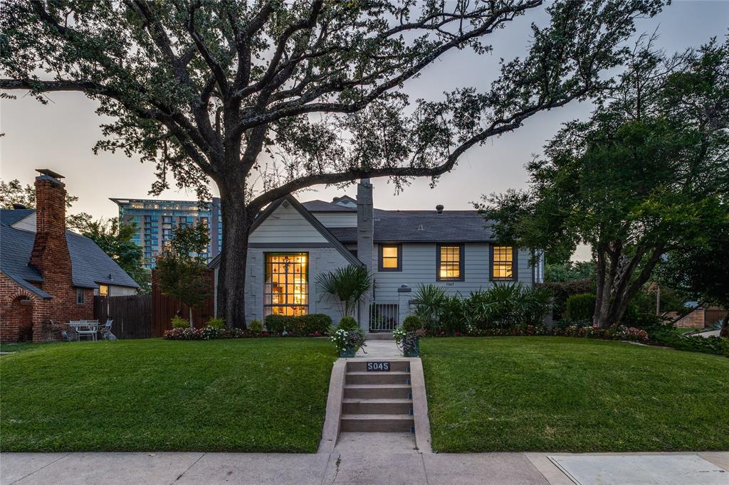 This Tudor home is a rare Charles Dilbeck design, reimagined in 2018 to embrace modern living while preserving its architectural soul. From the moment you arrive, the professionally landscaped gardens and gated stone patio set a tone of privacy and warmth, inviting you inside. Through the whimsical stained-glass front door, the formal living room unfolds like a page from a storybook. A soaring vaulted ceiling with exposed beams frames the space, where hardwood floors gleam through a breathtaking 1956 floor-to-ceiling stained-glass window. A marble fireplace anchors the room, offering both elegance and comfort.The heart of the home is the open family room and chef’s kitchen—spaces designed for gathering and entertaining. Here, the views stretch to the backyard oasis. The kitchen itself is a culinary dream: Calcutta white marble countertops and a waterfall island with seating for six, professional-grade Bertazzoni appliances, custom cabinetry, a built-in Fisher & Paykel refrigerator, and thoughtful details like a walk-in pantry, coffee bar, and solar shades. Beyond the French doors, the outdoors beckon. A sparkling pool crowned with a Poseidon water fountain, surrounded by flagstone walkways and patio, a full bath cabana, and lush landscaping. Upstairs, the primary suite is a sanctuary of its own. Vaulted ceiling and recessed lighting create a sense of serenity, while dual walk-in closets with custom built-ins offer convenience. The spa-inspired bath feels indulgent with soft blue cabinetry, double vanities topped in white marble, a soaking tub, and a walk-in shower. Two additional bedrooms, a full bath, a laundry room, and a versatile office or third living space complete the upper level, offering room to grow, work, and retreat. Centrally located, this home places you just moments from Dallas’s most beloved amenities—acclaimed restaurants, vibrant nightlife, serene parks, and the Katy Trail.This residence is ready to welcome its next chapter of memories!