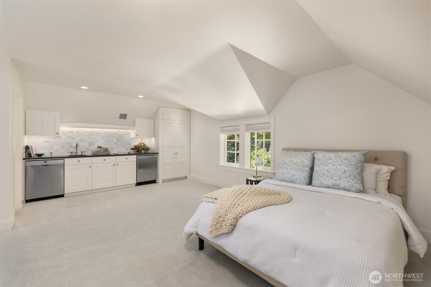 Versatile bonus room featuring a kitchenette and vaulted ceilings.