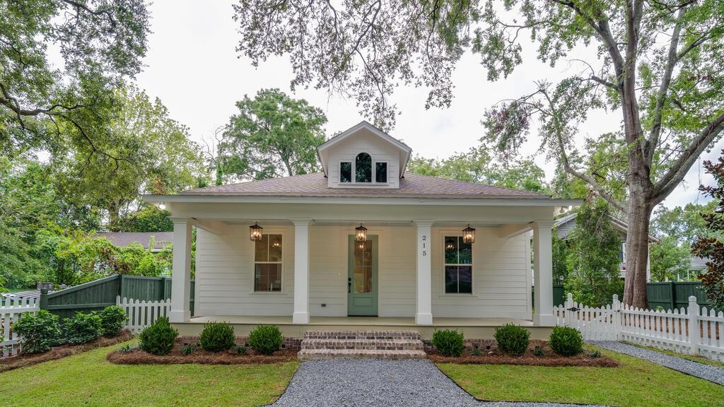 Experience the best of both worlds—brand-new construction thoughtfully designed to complement the historic charm of Downtown Thomasville. Located in the Historic District and approved by the Historic Preservation Commission (HPC), this one-of-a-kind home is approximately one block from The Big Oak and two blocks from the heart of downtown, putting shopping, dining, restaurants, and the charm of downtown Thomasville just moments away.  From the white picket fence and covered front porch to the impressive 8-foot entry doors, this home was intentionally designed to fit the character of the surrounding historic neighborhood. Imagine rocking chairs on the porch, a glass of sweet tea, and the canopy of the beautiful mature oak tree that was carefully preserved along Clay Street.  Step inside and you'll immediately notice the impressive 10-foot ceilings with 11-foot tray ceilings, creating an open and spacious feel throughout the home. The interior was professionally designed with the assistance of an interior designer, blending historic-inspired character with the comfort and finishes of new construction.  The kitchen is a centerpiece of the home, featuring quartz countertops, abundant cabinetry, generous workspace, stainless-steel appliances, a gas range with vent hood, and plenty of room for cooking, gathering, and entertaining.  The primary suite continues the elevated design with 10-foot ceilings and an 11-foot tray ceiling and connects to a luxurious private bathroom featuring a spacious tiled walk-in shower with built-in niches for toiletries. The custom walk-in closet provides extensive storage along with dedicated shoe storage and thoughtfully designed organization space.  Even the Jack-and-Jill bathroom received special attention, featuring a tub with tile extending all the way to the ceiling, continuing the quality and attention to detail found throughout the home.  Outside, enjoy professional landscaping, a privacy-fenced backyard, and a covered rear wood porch designed for relaxing and entertaining. The mature oak was intentionally preserved, maintaining the beautiful tree canopy and established character that makes Clay Street so special.  This is a rare opportunity to own brand-new construction in Thomasville's Historic District—a home designed to respect the neighborhood's historic charm while providing the finishes, efficiency, and conveniences of modern construction. With downtown just a short walk away, 215 E Clay Street truly offers the best of both worlds and is a must-see.  Seller is a licensed real estate broker in the state of Georgia license number 340473