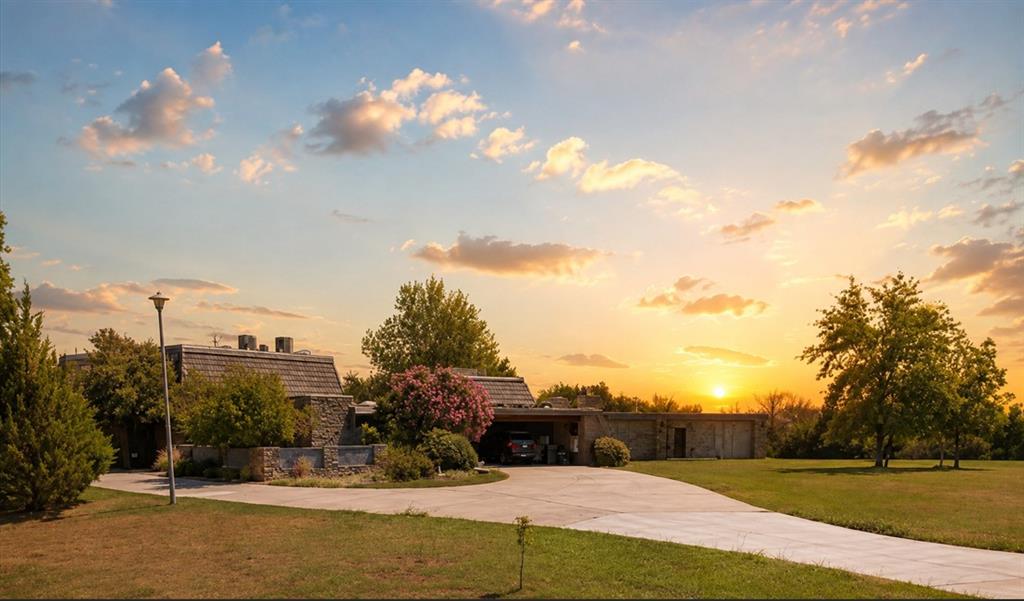 Welcome to this exceptional Mid-Century Modern estate nestled along a private road with no through traffic, offering peaceful surroundings, beautiful grounds, and exceptional privacy. This one-of-a-kind property combines distinctive architectural design with thoughtful updates and an abundance of amenities. A curved driveway and porte cochère welcome you to a striking two-story foyer with spiral staircase. The great room features custom built-ins, a wood-burning fireplace, and views of the beautiful solarium, while the library and private bar room provide inviting spaces for relaxation and entertaining.The curved kitchen features original cabinetry, quartz countertops, and a walk-in pantry and flows into the formal dining area accented by beautiful stone walls. The main residence offers spacious bedrooms with ensuite baths, while the connected guest wing provides an ideal multigenerational living arrangement with its own entrance, kitchen, living and dining areas, bedroom suite, and additional baths. Large windows throughout bring in natural light and showcase the surrounding grounds.Enjoy breathtaking views of the city and Tinker AFB from the second-floor deck, which has been replaced within the last two years. The property also features a fenced backyard, heated saltwater pool, swim spa, balcony, four-car garage, 30x40 shop, outbuildings, storm shelter, and guest accommodations. Recent improvements include replacement of all HVAC units within the last two years, a new well pump, whole-house water filtration system, and reverse osmosis systems in both kitchens.Enjoy your morning coffee from the deck while watching the abundant wildlife, including deer, raccoons, squirrels, roadrunners, coyotes, turkeys, and more. With beautiful grounds, peaceful surroundings, expansive outdoor spaces, and the privacy of a no-through-traffic road, this extraordinary property offers a rare combination of character, comfort, and tranquility.